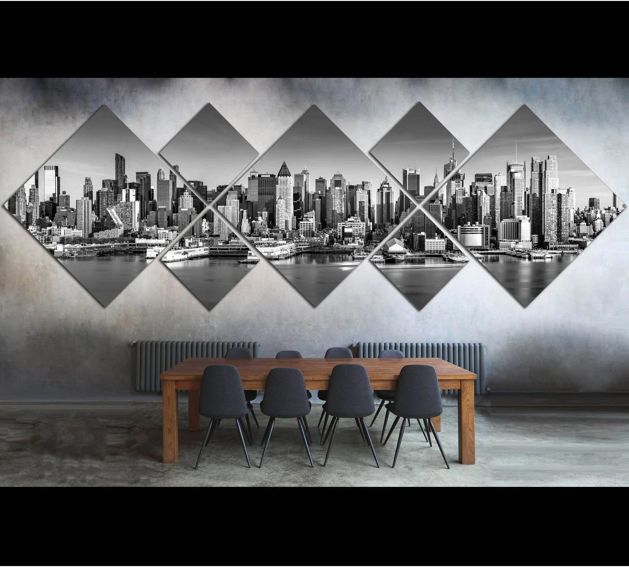 Black and white NYC skyline canvas print on diamond panels above a dining table in a modern loft interior