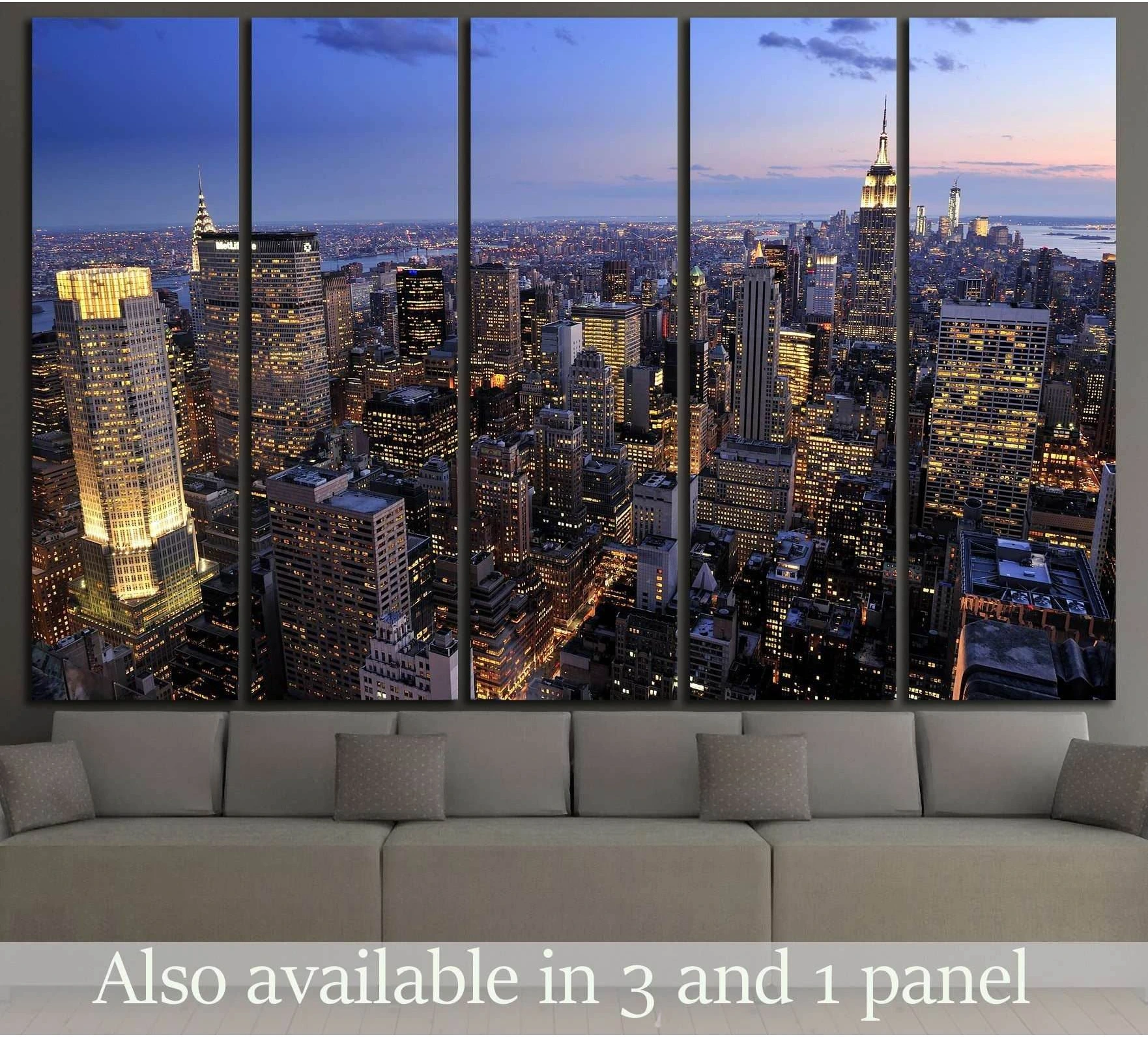Five-panel NYC skyline canvas print above a sofa in a modern living room at dusk