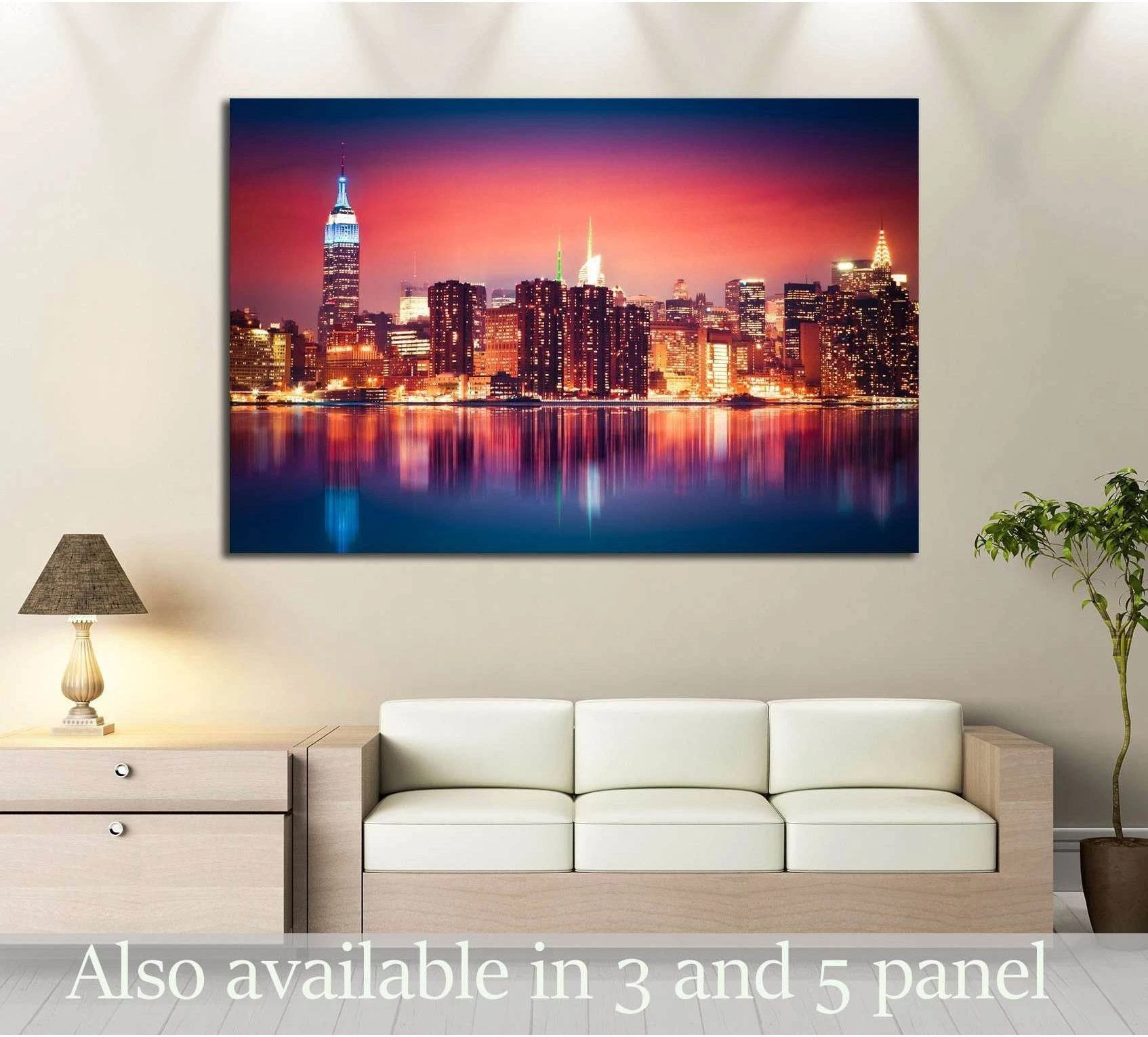Colorful Manhattan skyline canvas print at night above a sofa in a modern living room
