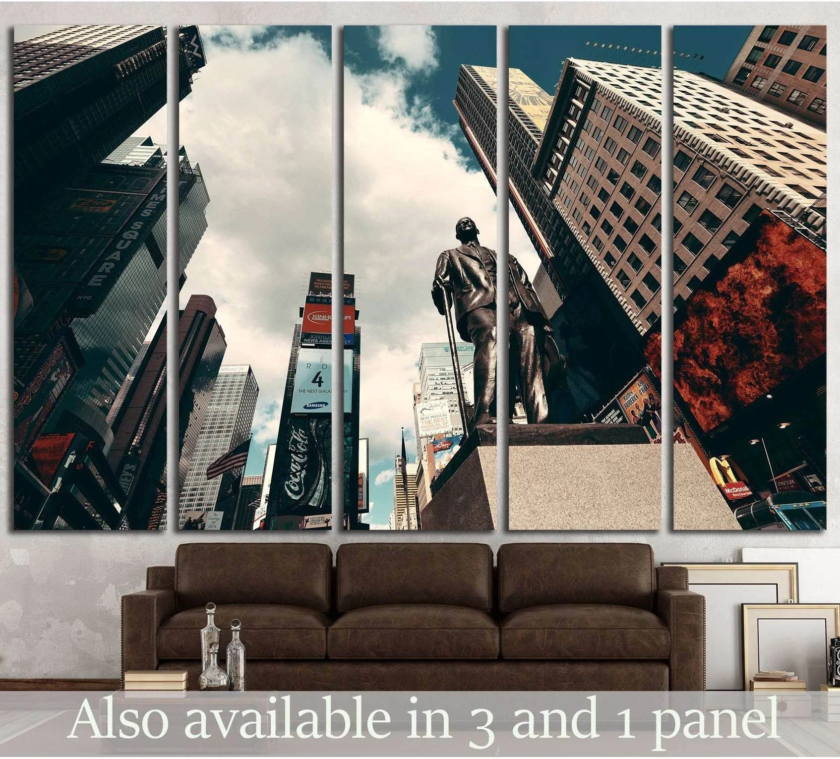 Times Square canvas print with Manhattan skyscrapers and statue, displayed above a sofa