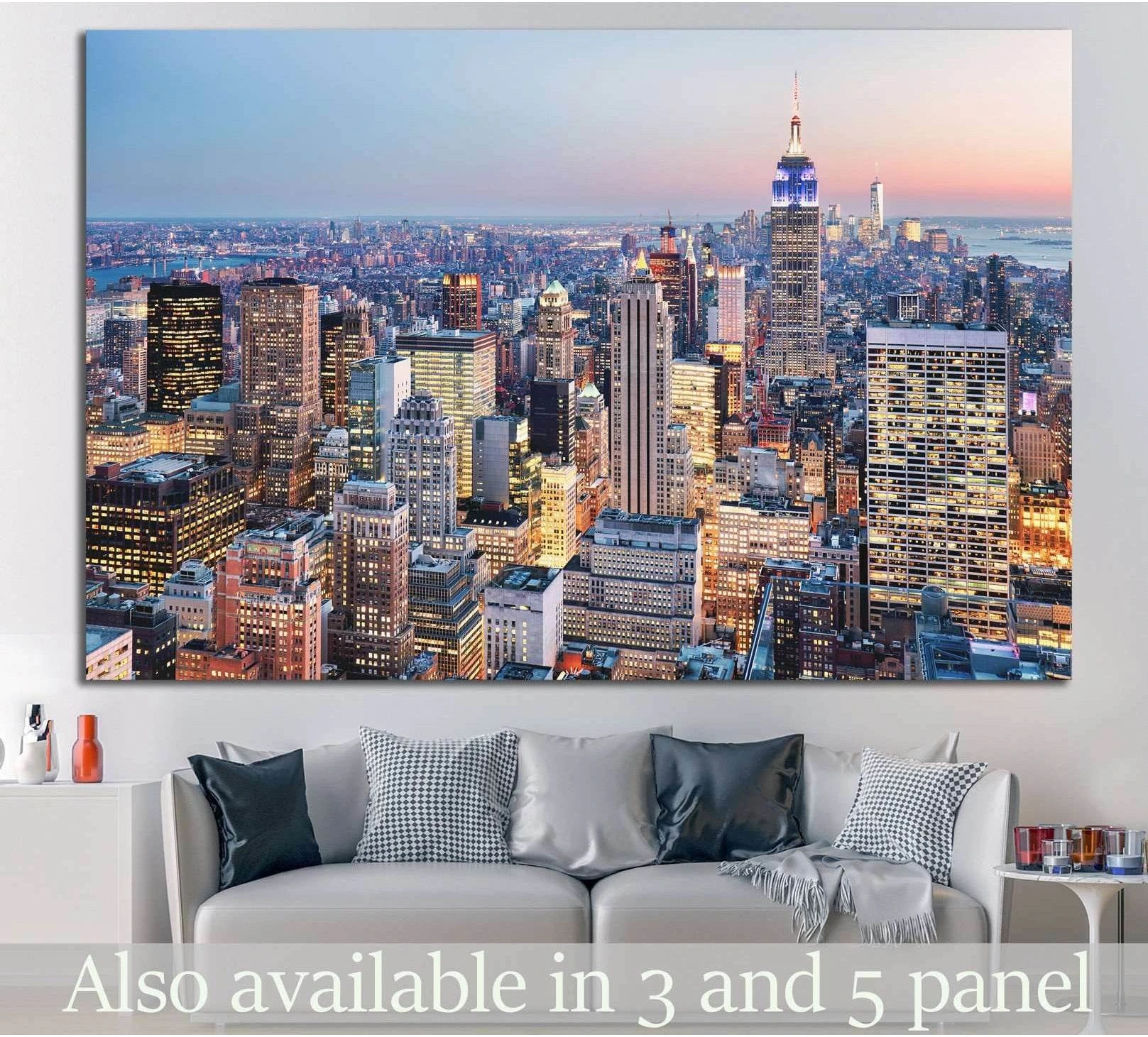 New York City skyline canvas print with the Empire State Building at dusk above a sofa in a modern living room