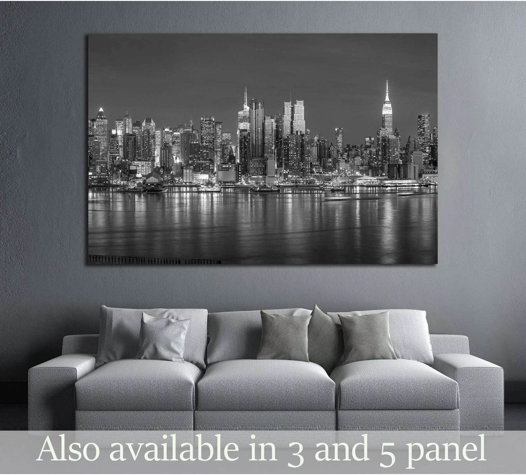 Black and white NYC skyline canvas print above a sofa in a modern living room