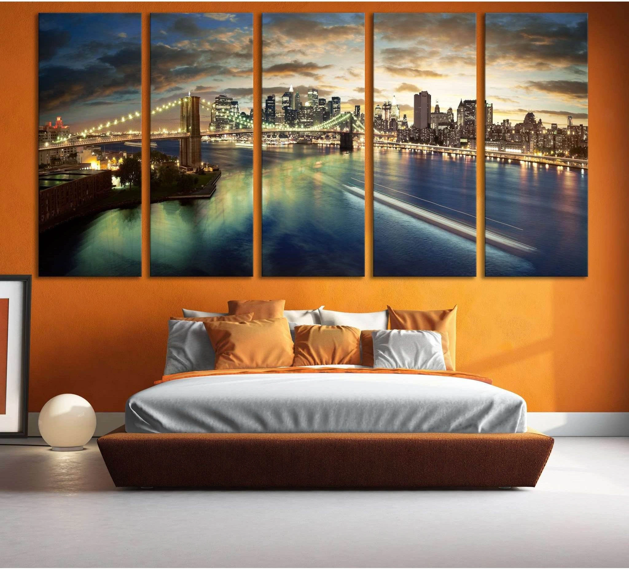 Brooklyn Bridge NYC skyline canvas print hung above a bed in a warm modern bedroom
