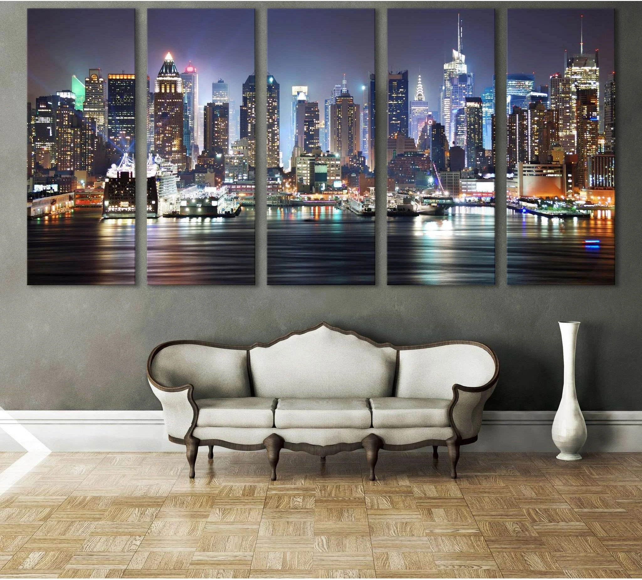 Five-panel NYC skyline canvas print with Manhattan lights over water above a sofa