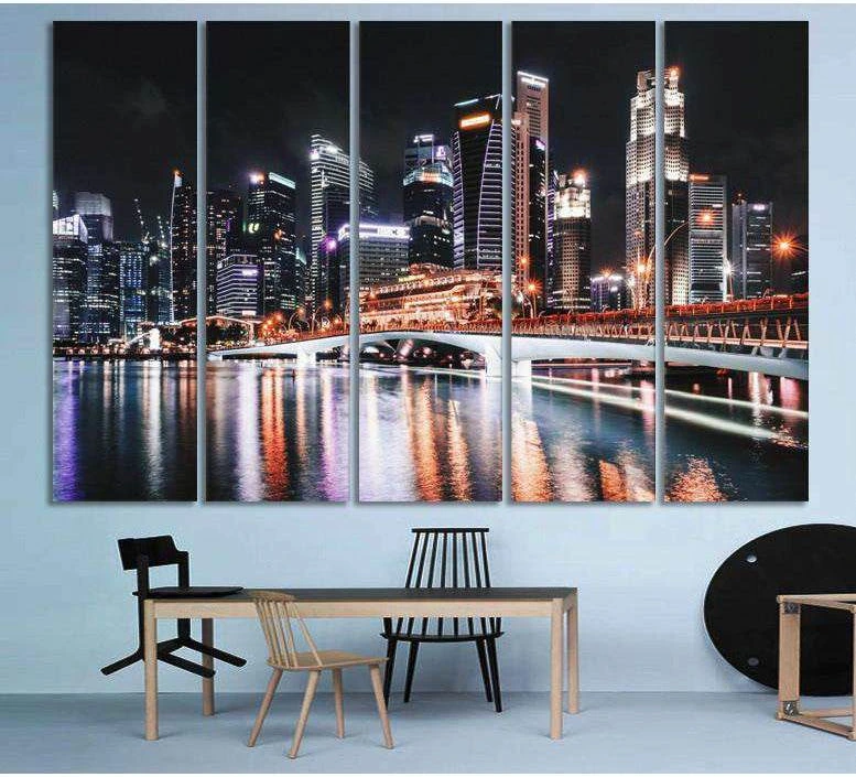 Night city skyline canvas print with illuminated bridge and reflections, displayed above a dining table
