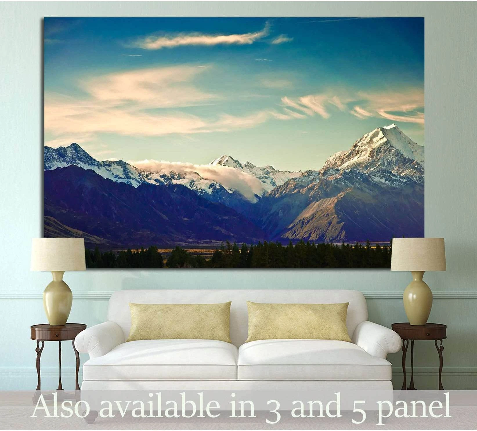 New Zealand mountain canvas print above sofa with snow-capped peaks and teal sky in living room