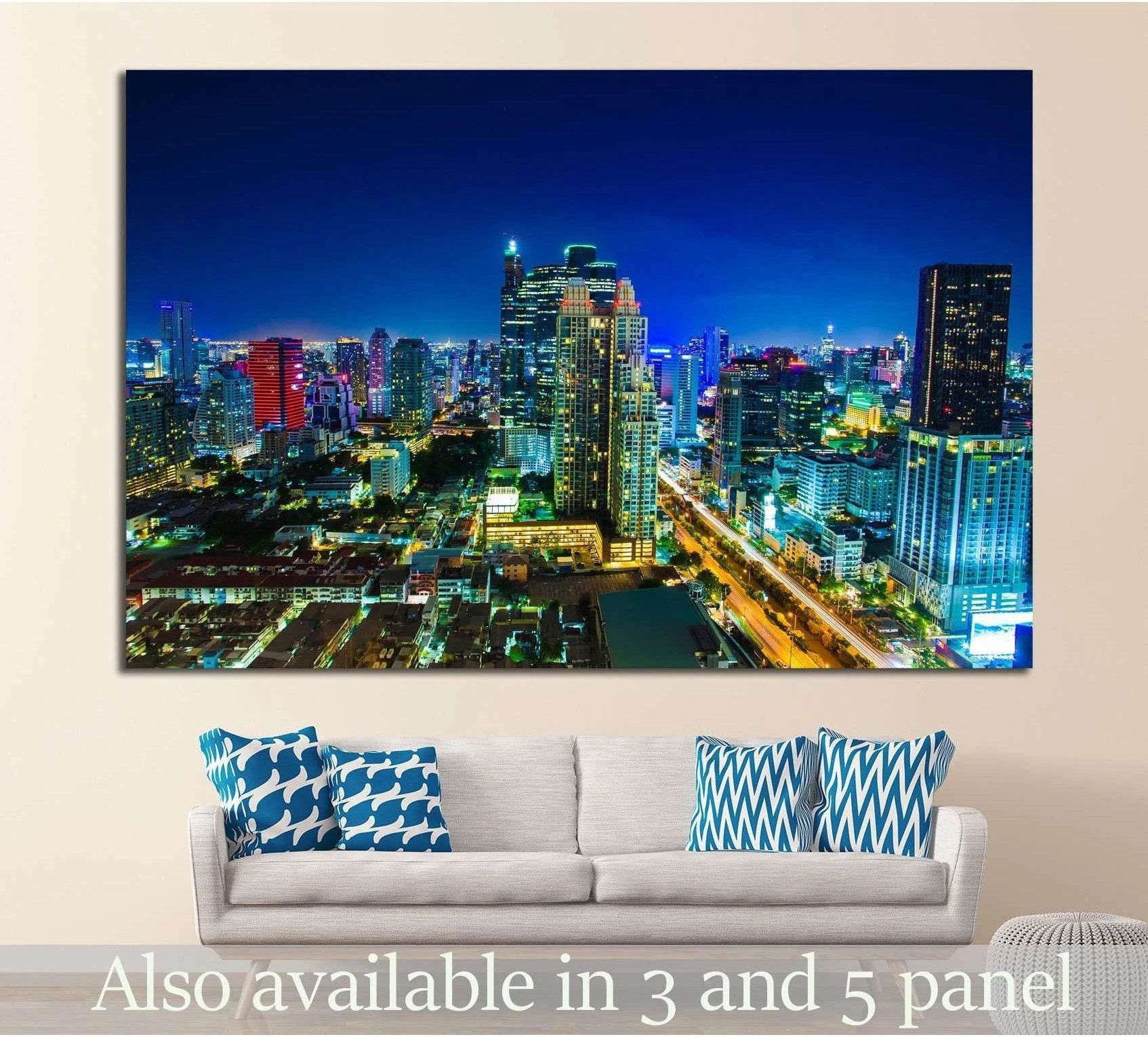 Night city skyline canvas print above sofa in modern living room with blue and gold lights