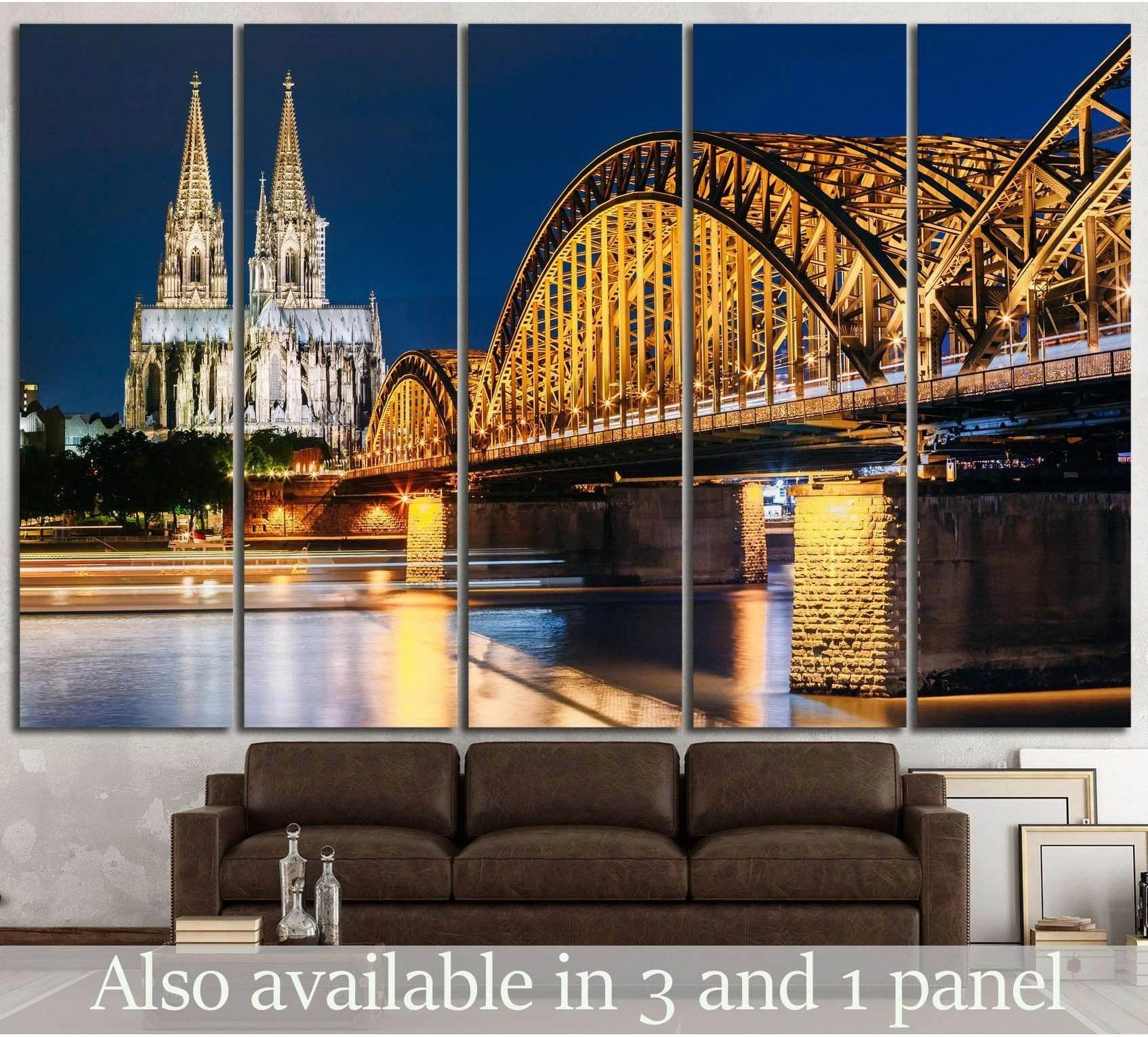 Cologne Cathedral and Hohenzollern Bridge canvas print at night above a sofa in a modern living room