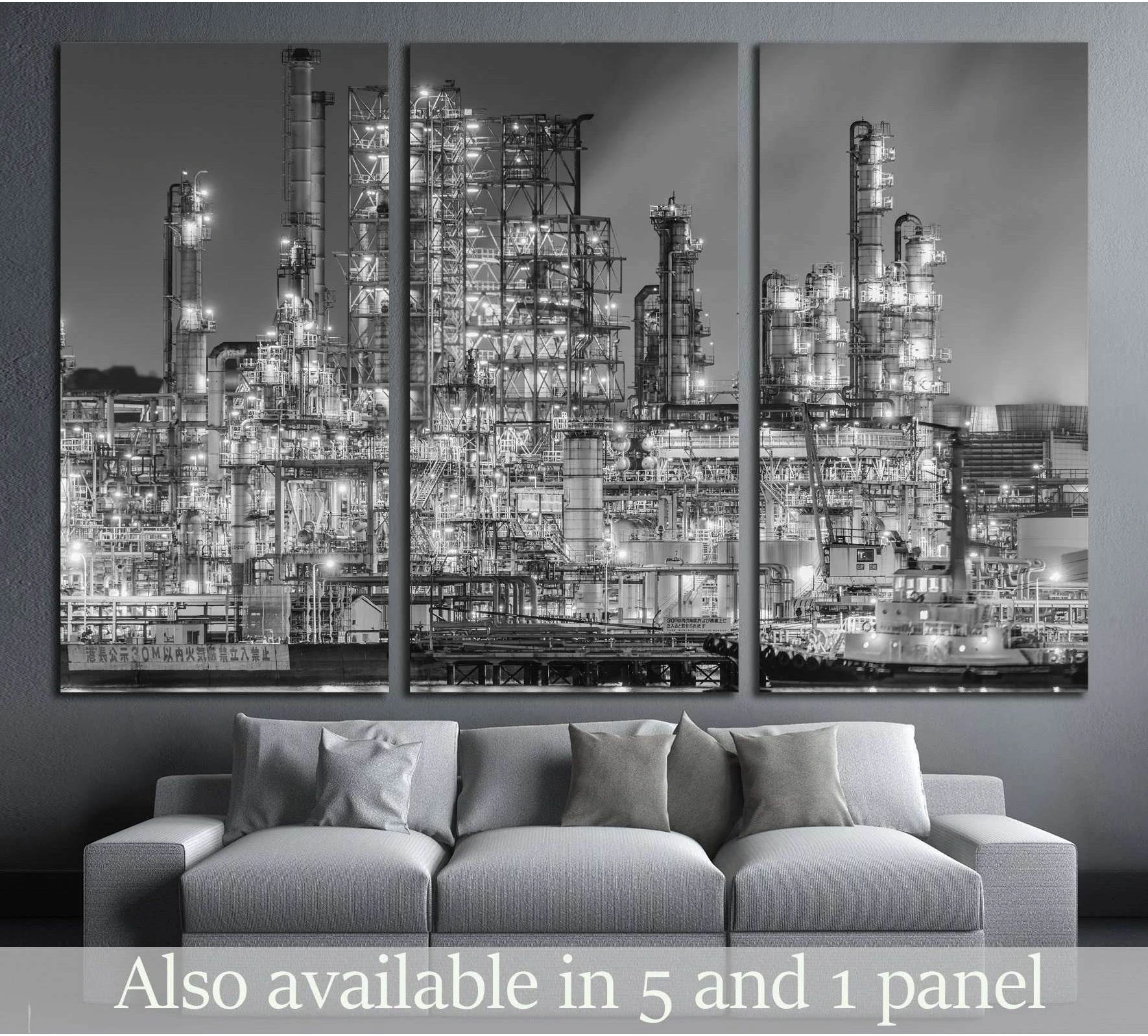 Black and white refinery factory canvas print at night displayed above a sofa in a modern living room