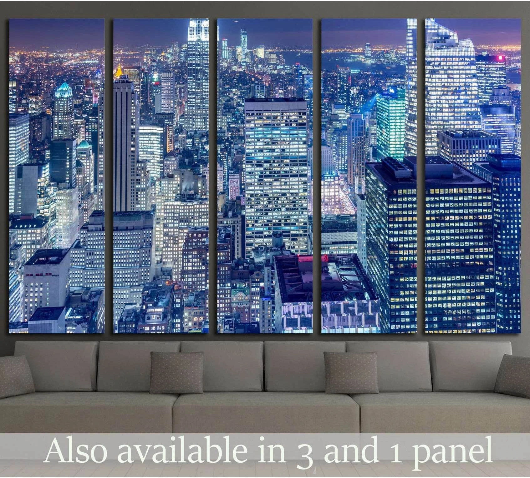 Manhattan skyline canvas print in cool blue dusk tones above a sofa in a modern living room