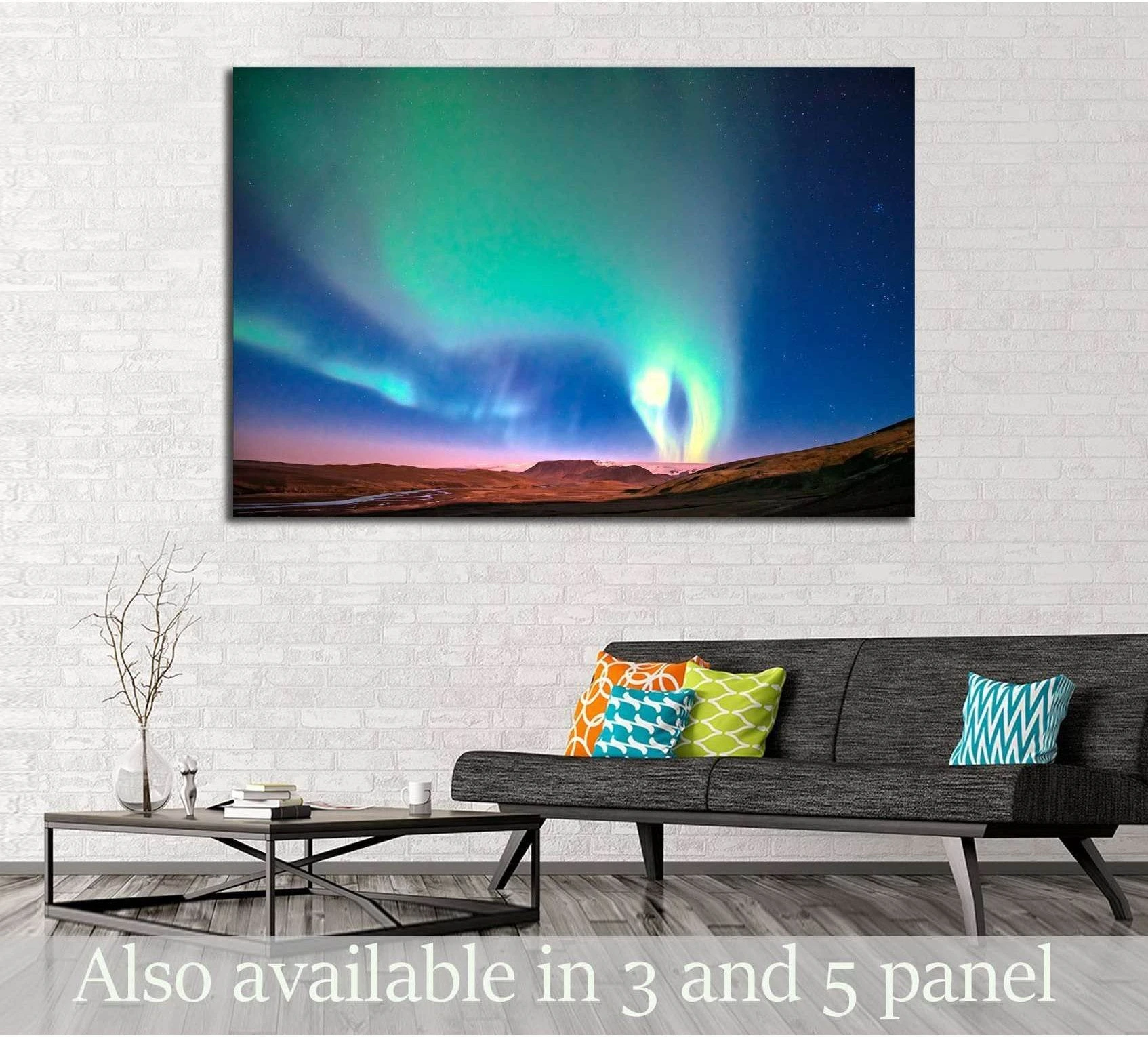 Northern lights canvas print above a sofa with teal and blue aurora over a panoramic landscape