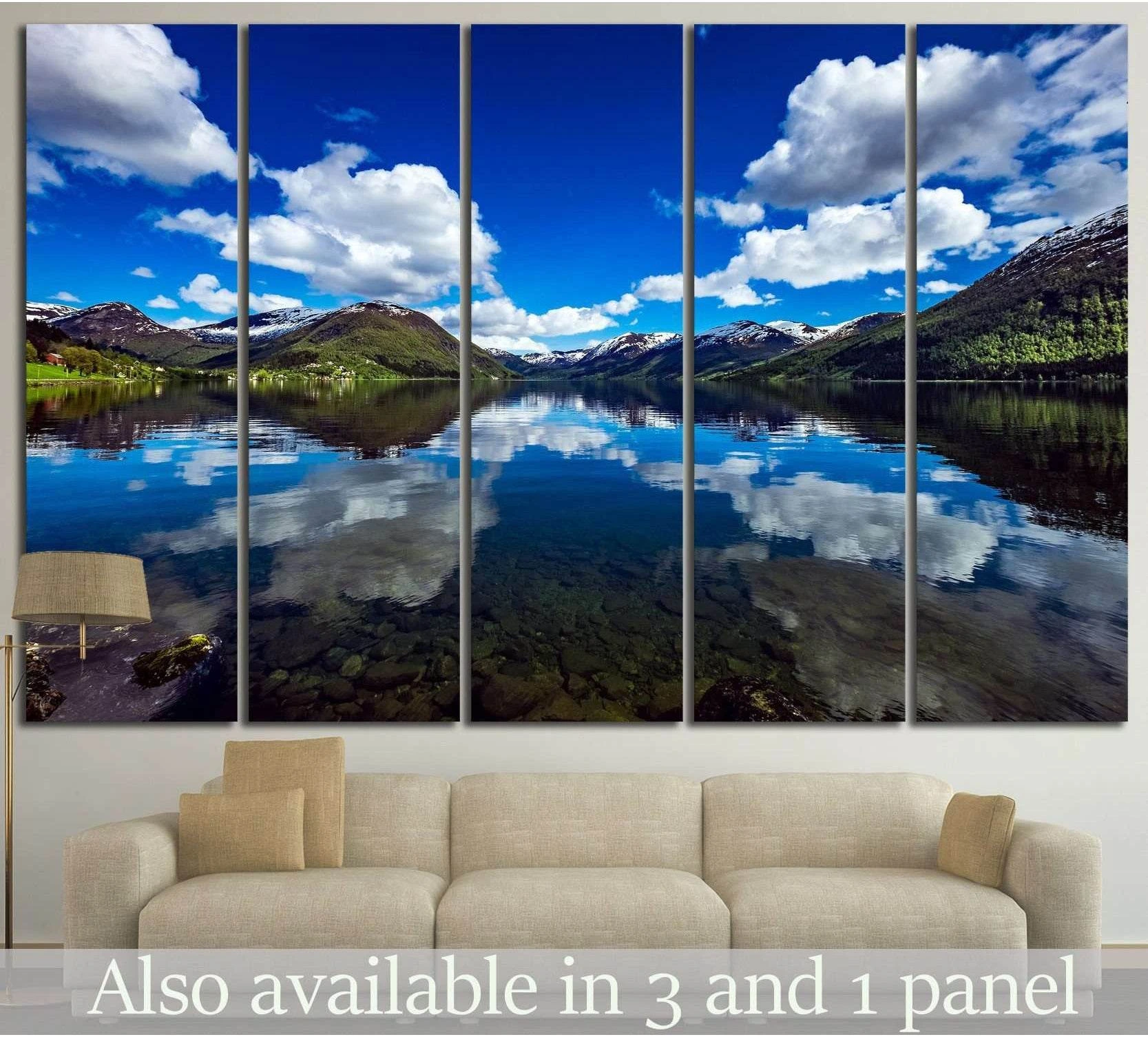 Norwegian fjord canvas print with mirrored mountain lake, blue sky, and clouds above a sofa