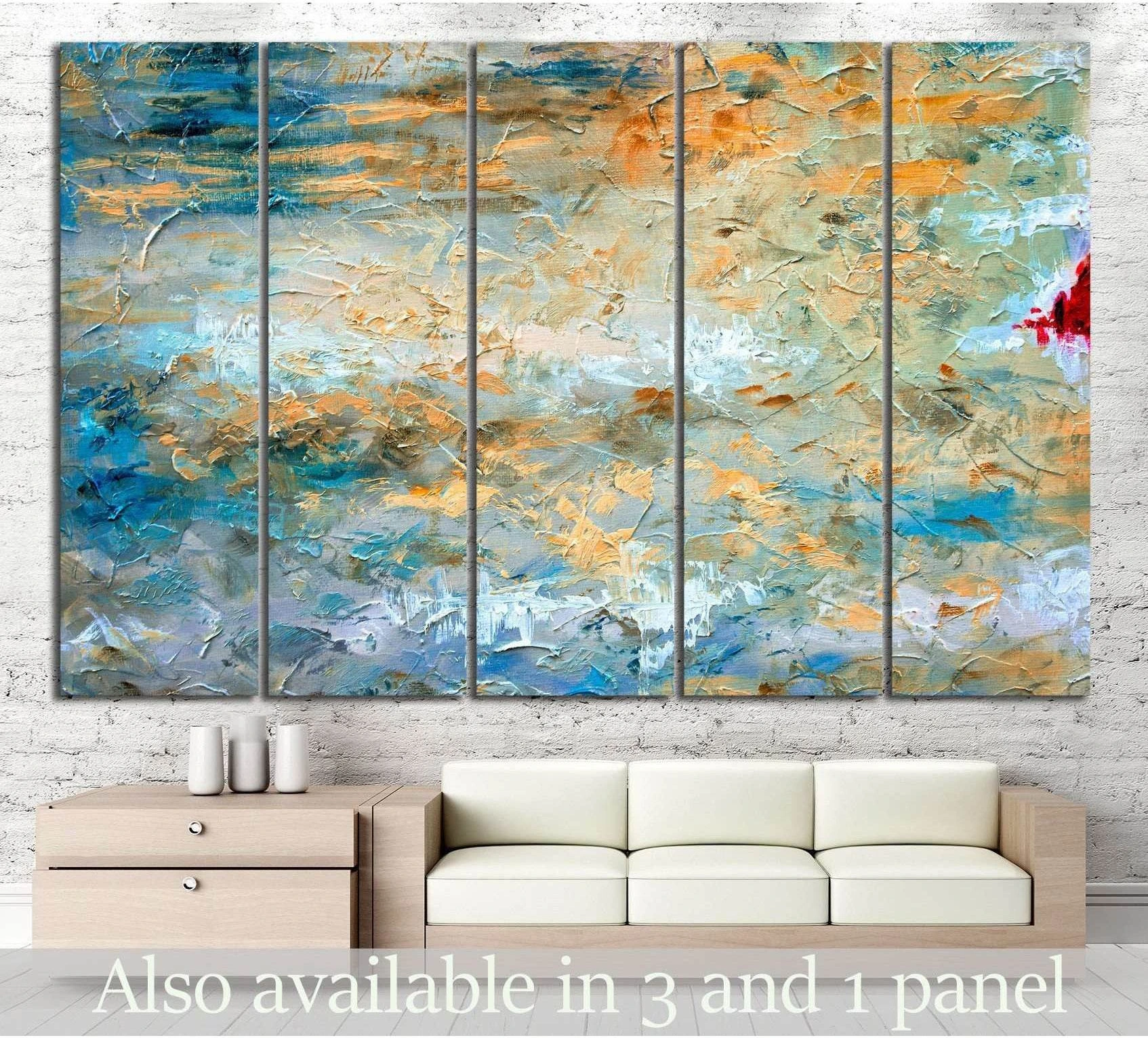 Blue and gold abstract canvas print in five panels above a sofa in a modern living room