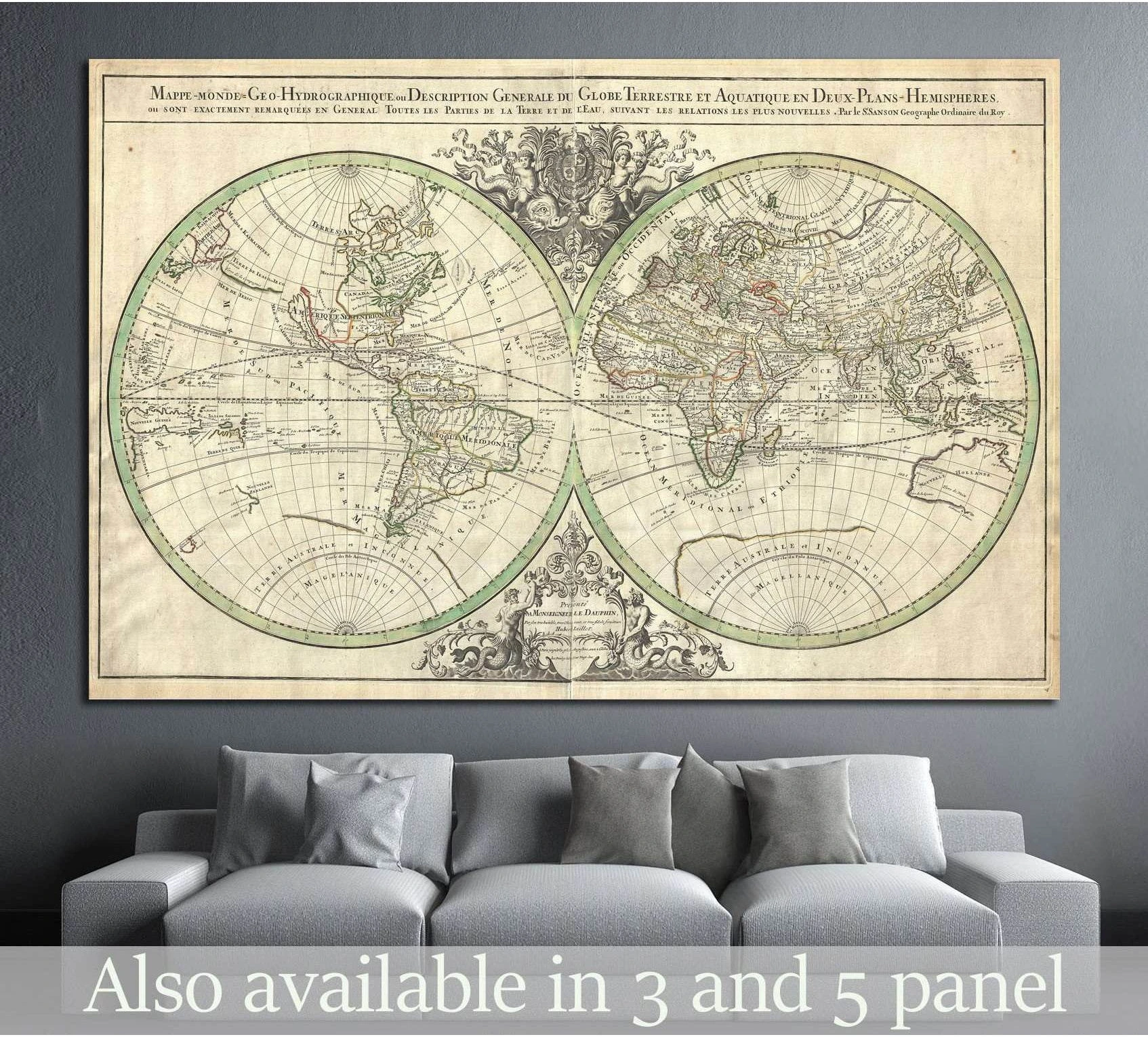 Antique double hemisphere world map canvas print hung above a gray sofa in a dark modern living room
