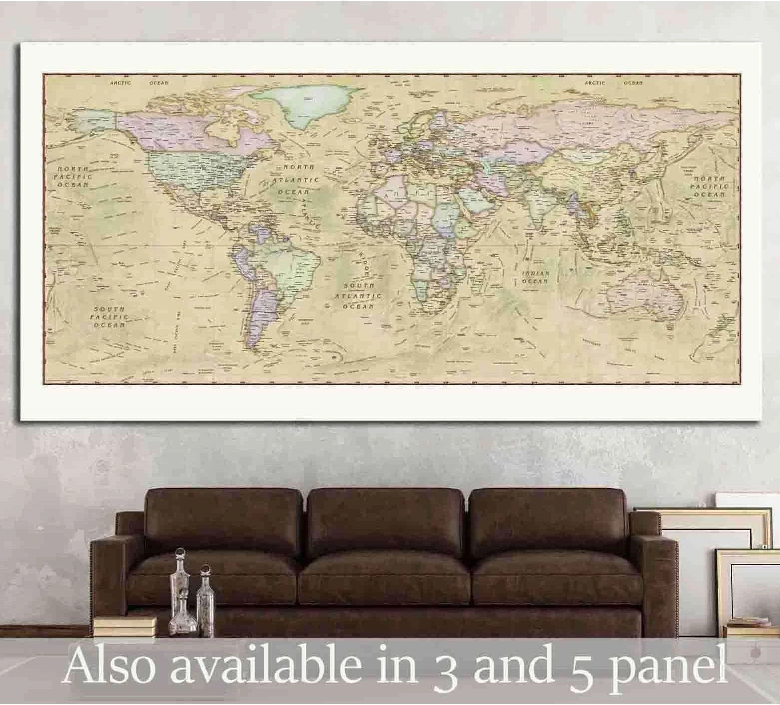 Antique world map canvas print in soft beige tones displayed above a brown sofa
