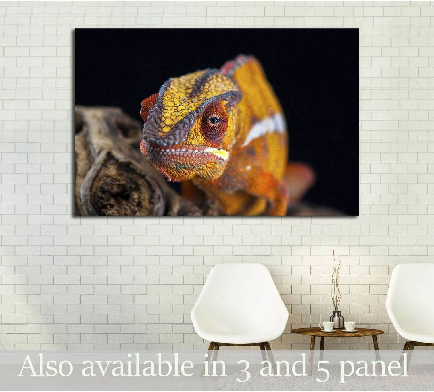 Orange chameleon canvas print hung above chairs in a modern room with white brick wall