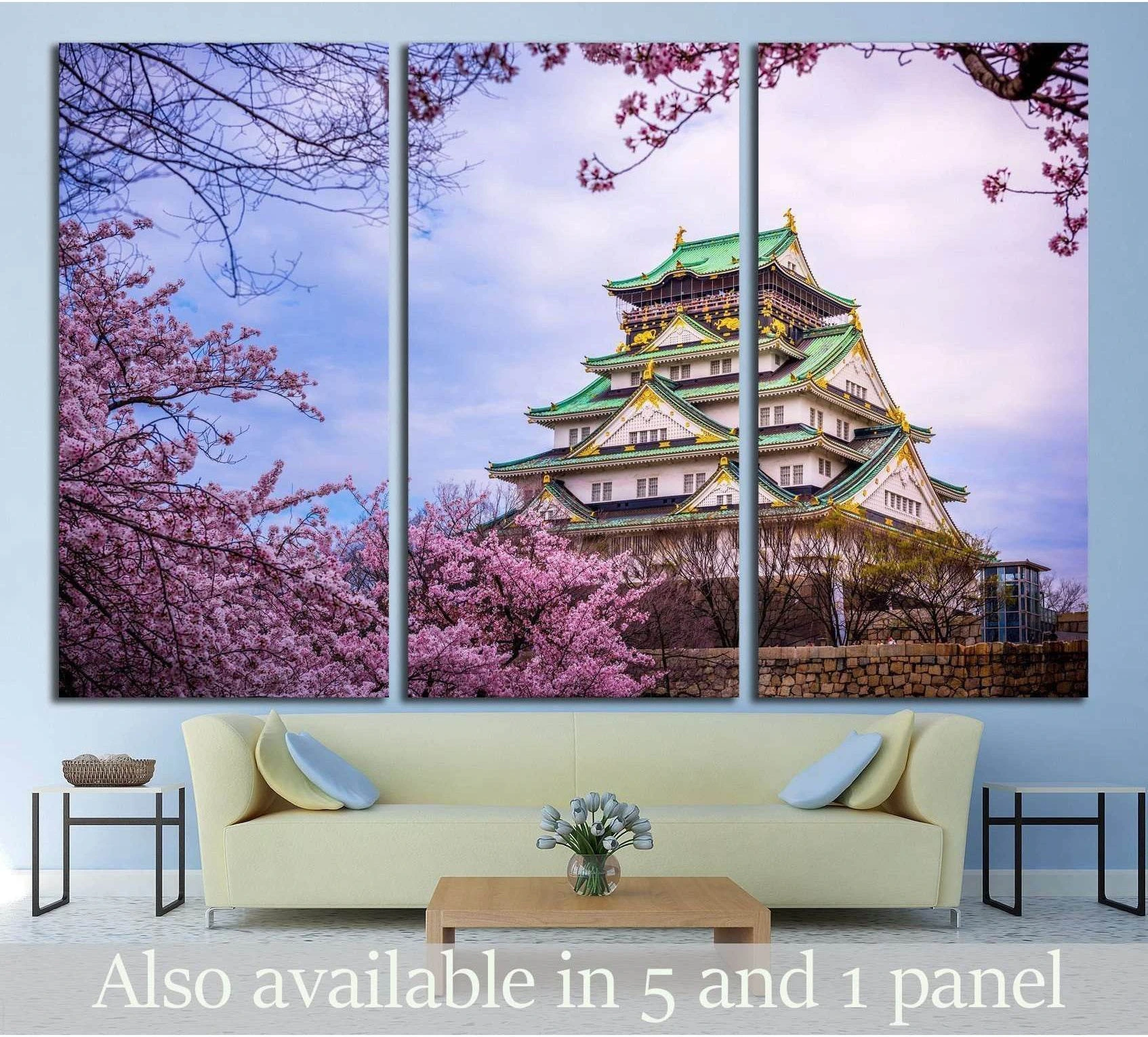 Osaka Castle canvas print with pink cherry blossoms hung above a sofa in a modern living room