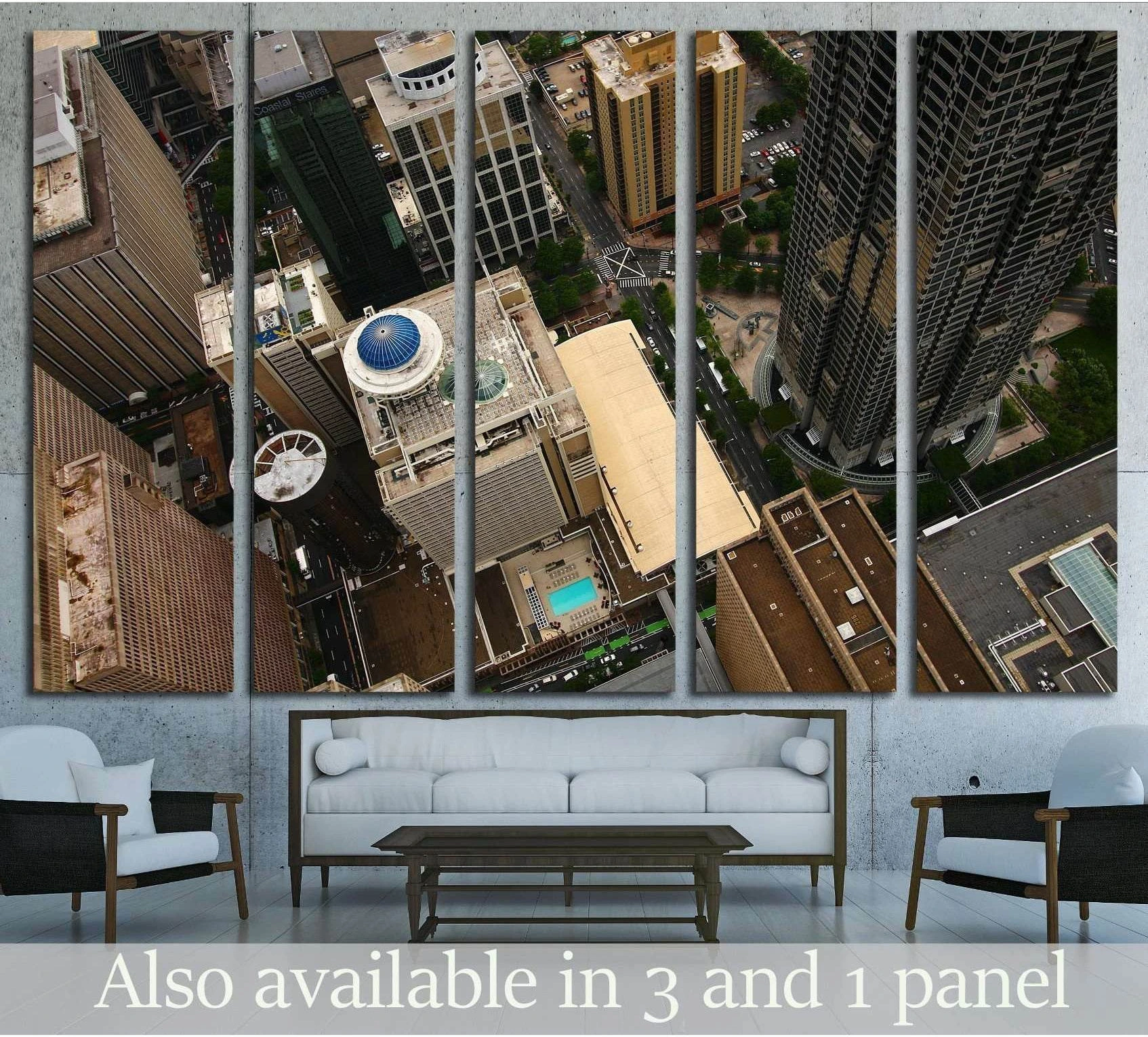 Atlanta aerial canvas print showing downtown skyscrapers from above, displayed above a sofa