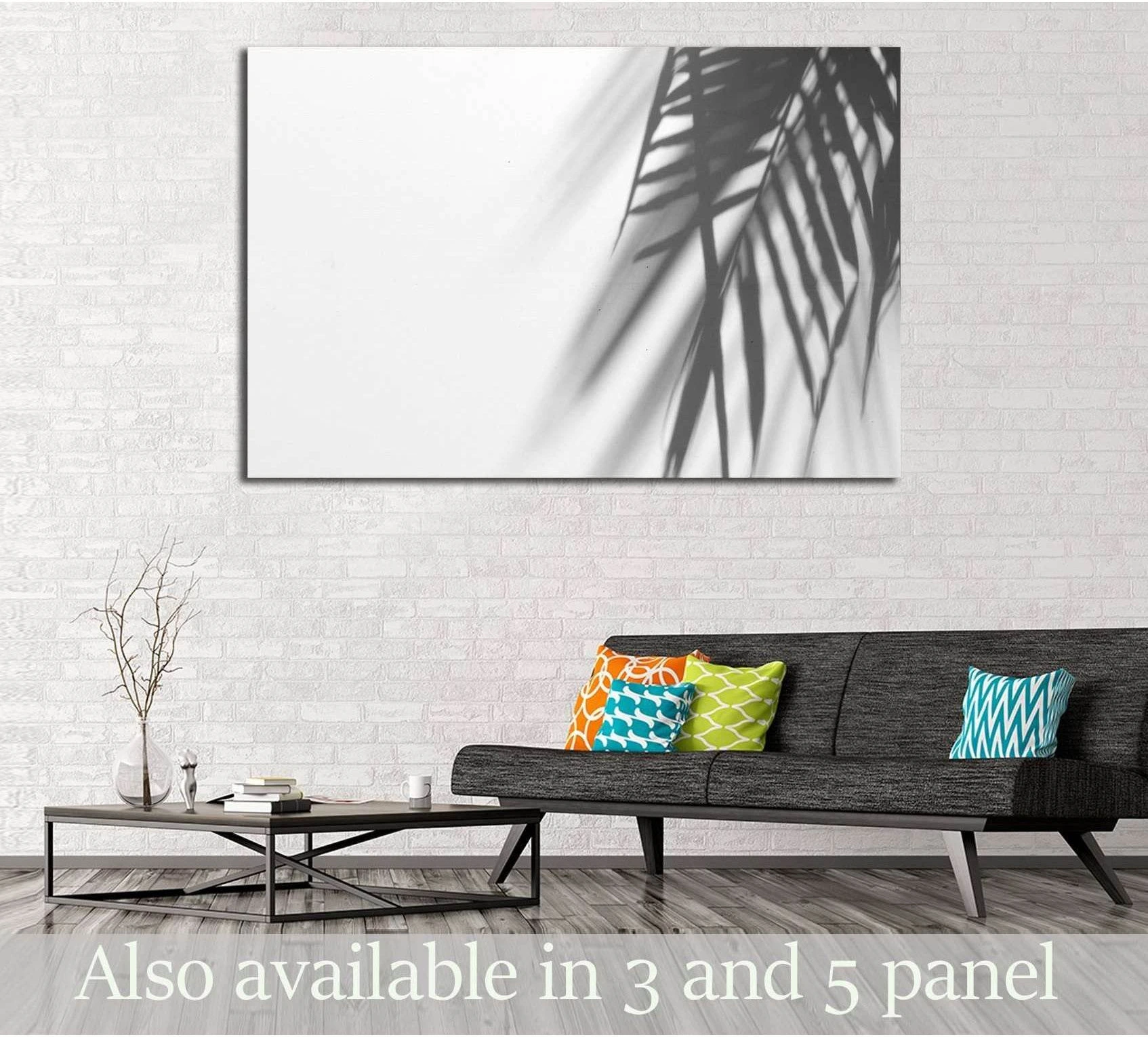 Palm leaf shadow canvas print on white wall above sofa in a modern minimalist living room