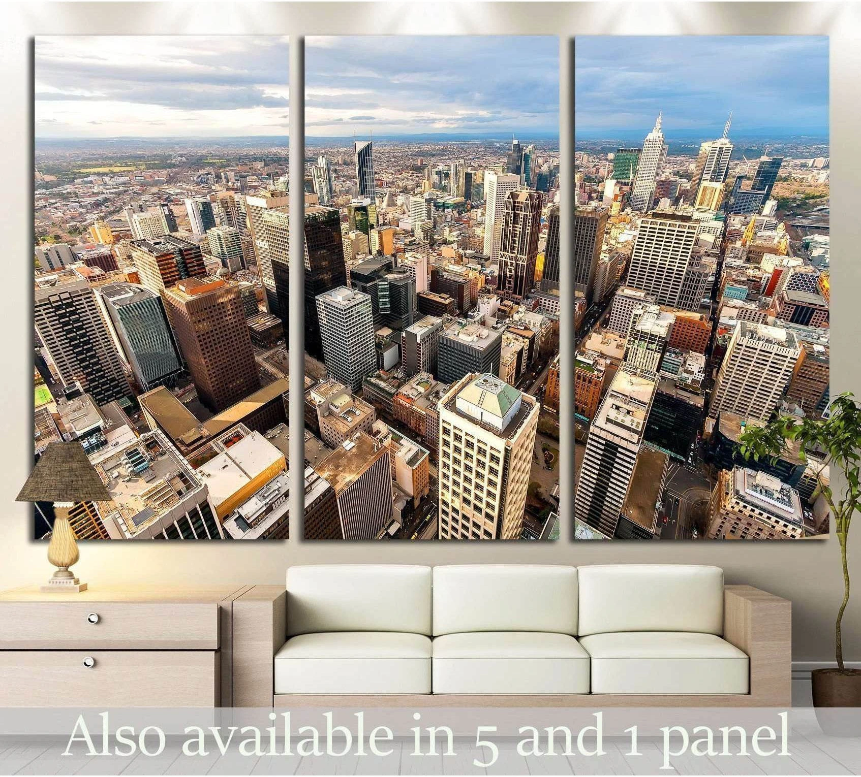 Aerial Melbourne city centre skyline triptych canvas print hung above a sofa in a modern living room