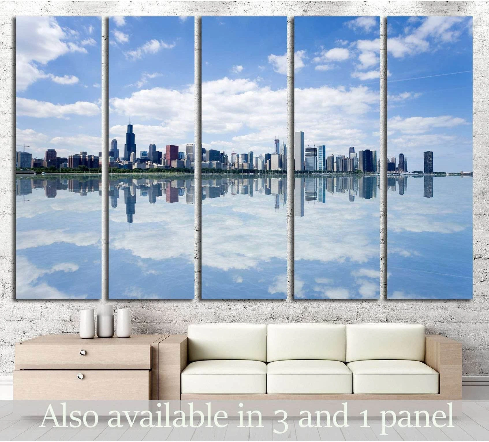 Chicago skyline panoramic canvas print with mirrored waterfront, displayed above a sofa in a modern living room