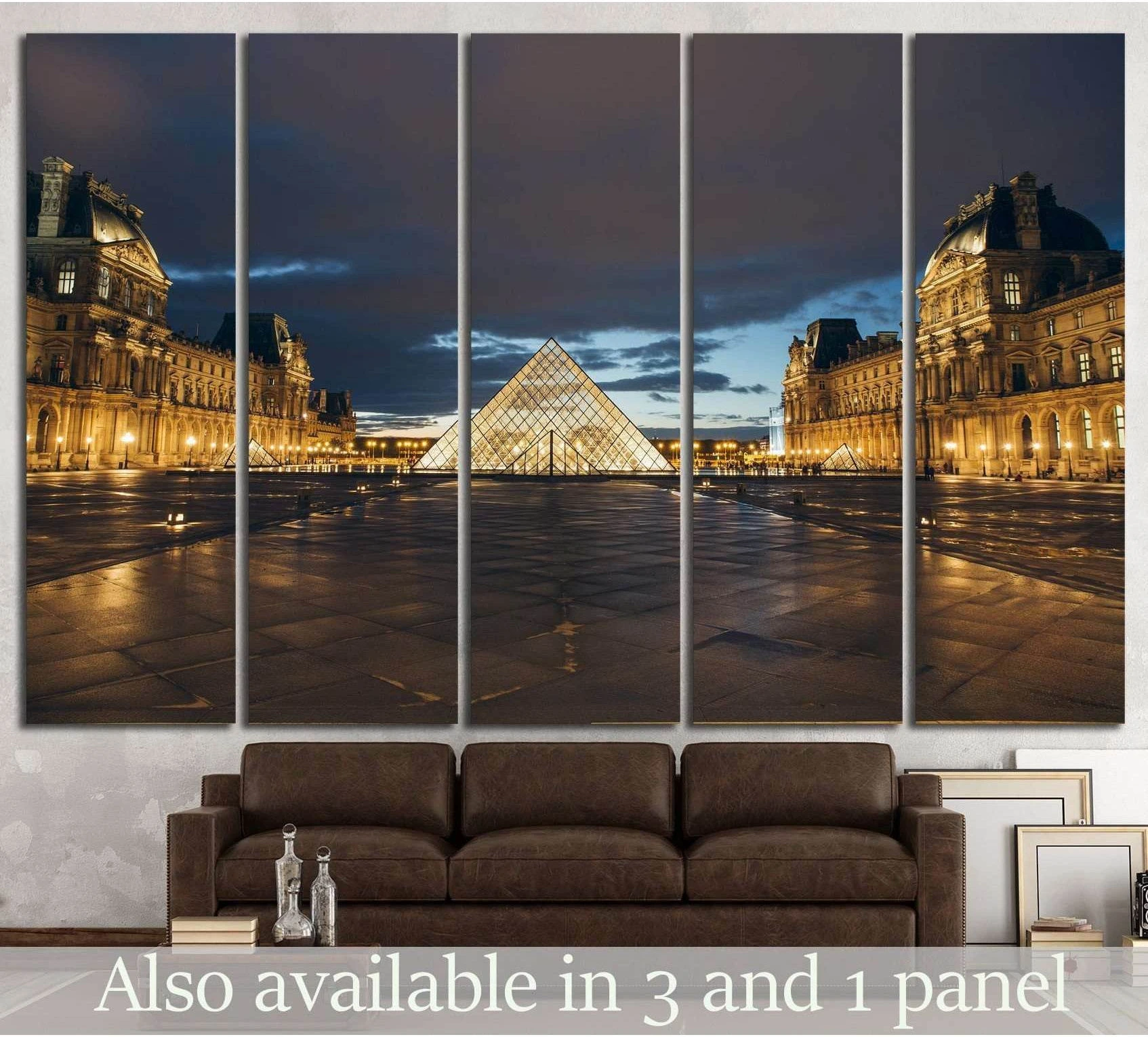 Paris Louvre Museum canvas print with glowing glass pyramid at dusk above a brown sofa