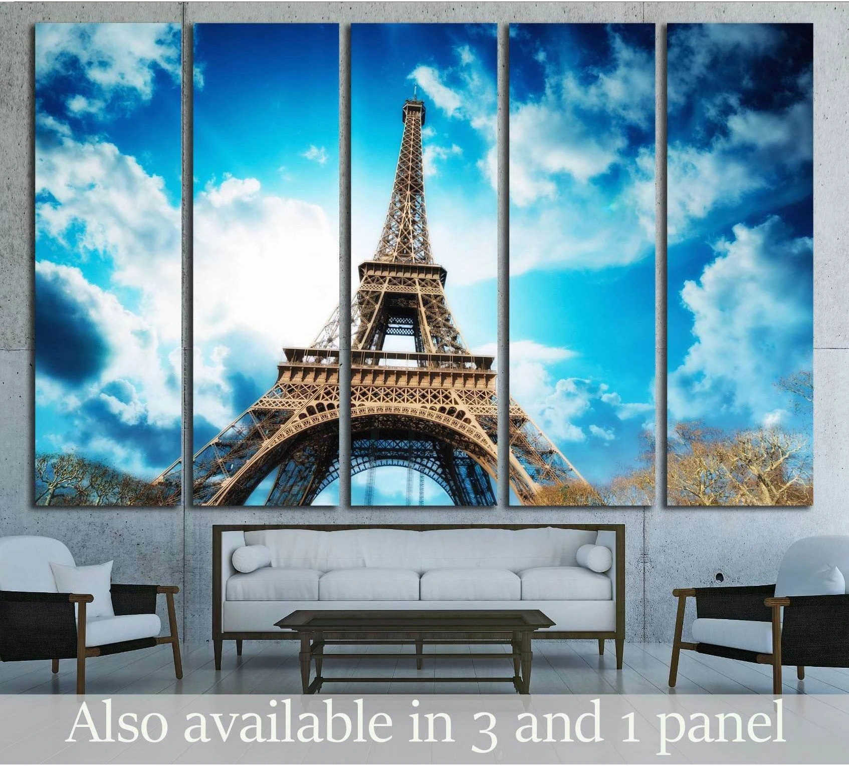 Eiffel Tower multi-panel canvas print with blue sky clouds above sofa in modern living room