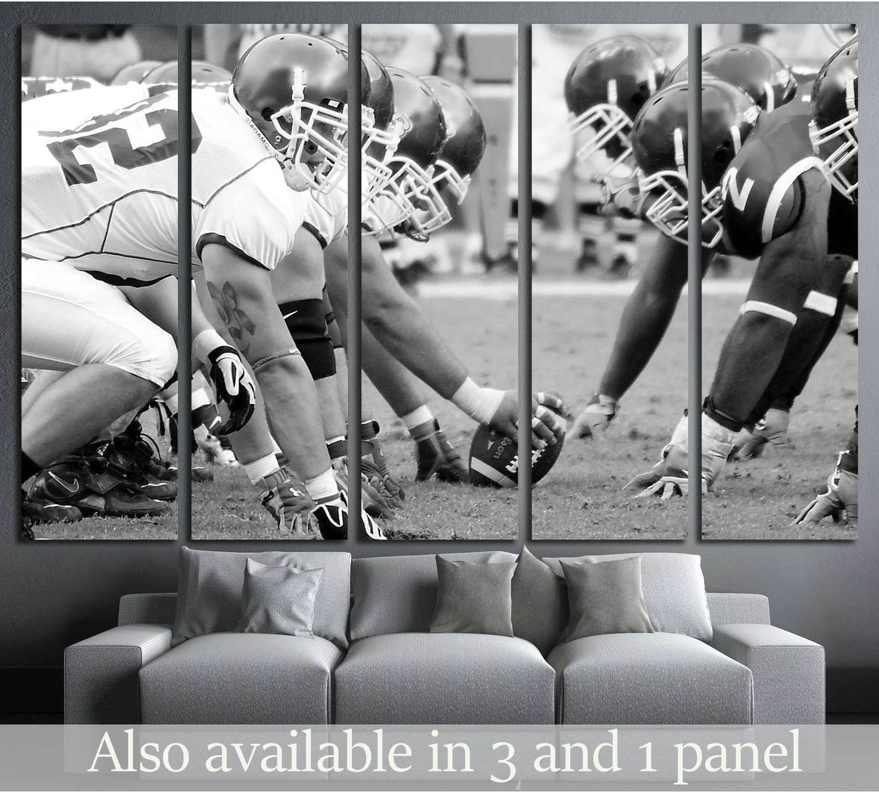 Black and white football canvas print with linemen at the line of scrimmage above a gray sofa