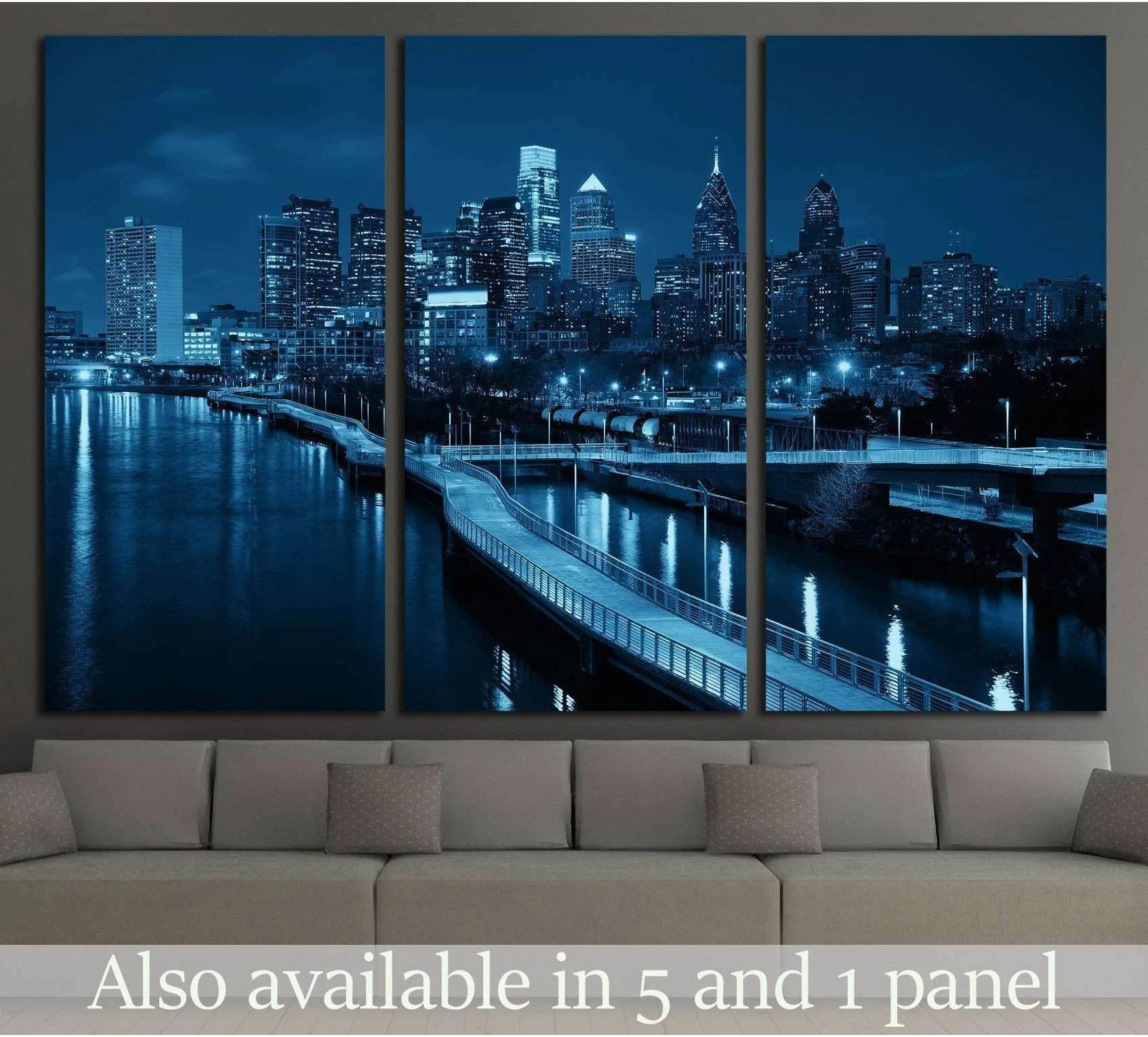 Philadelphia skyline triptych canvas print at night above sofa in a modern living room