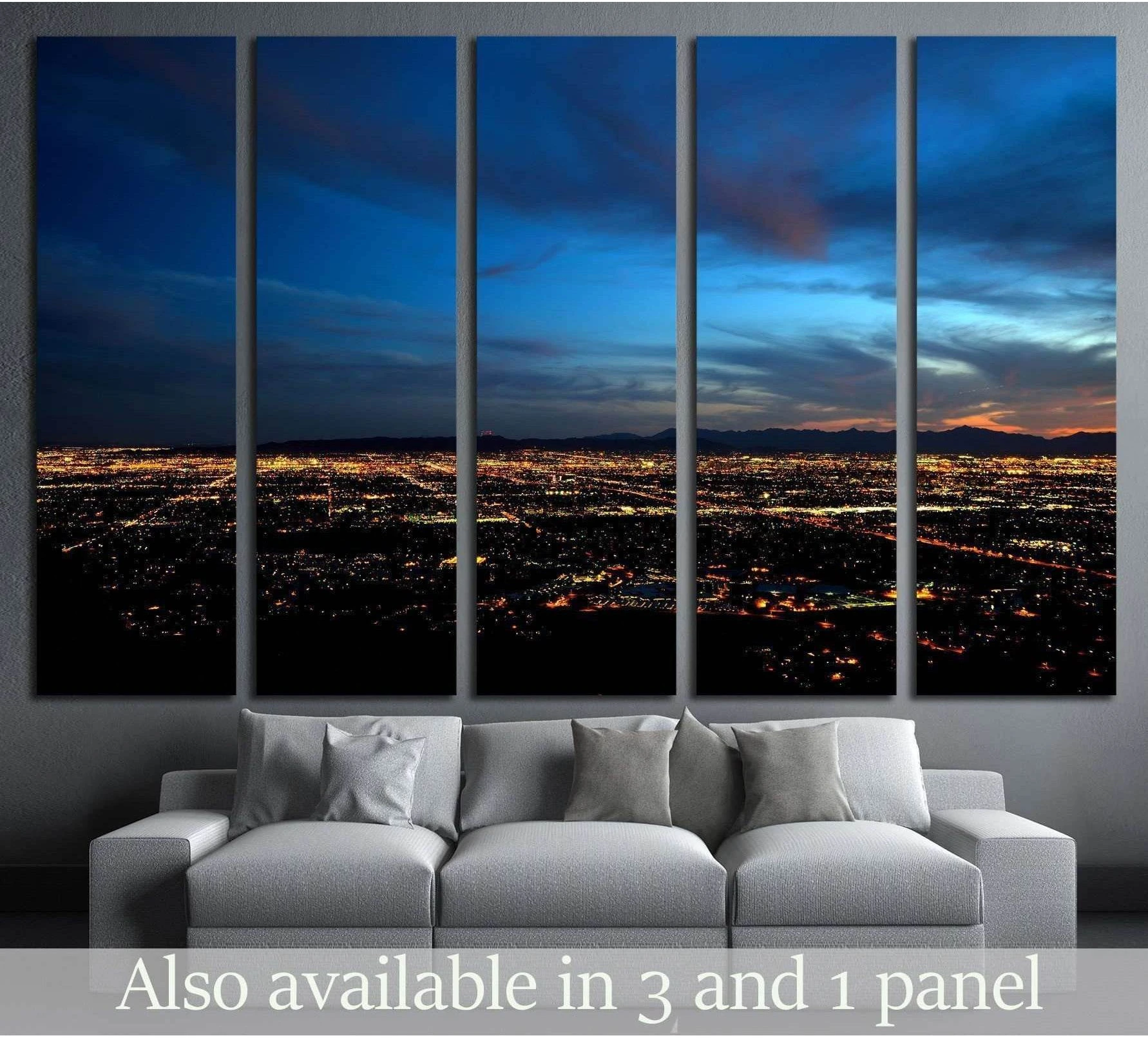 Phoenix skyline canvas print with glowing city lights at dusk above a sofa in a modern living room