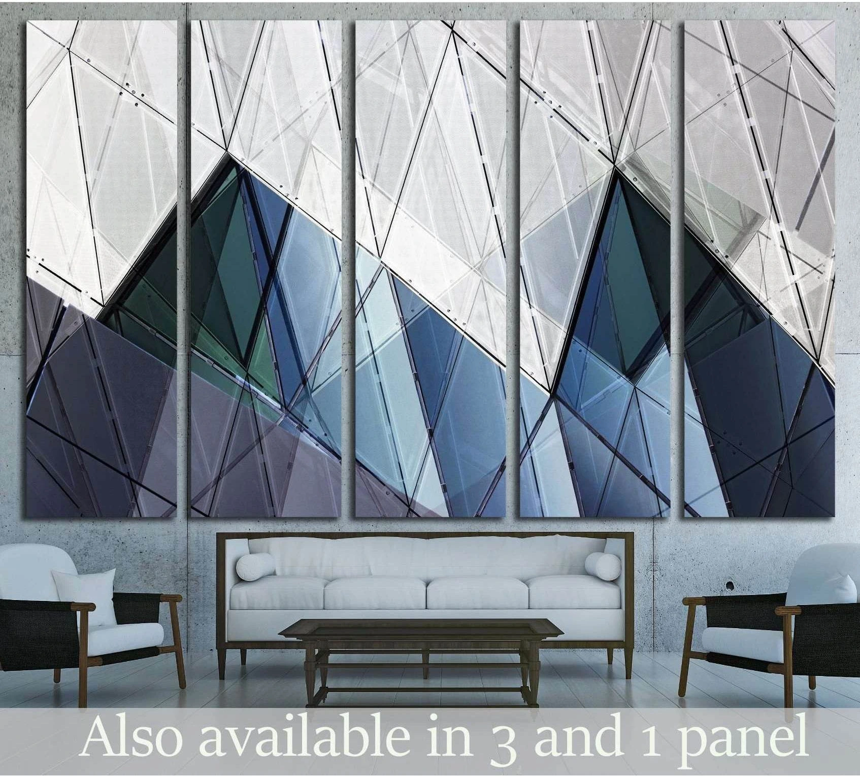 Blue grey architectural canvas print with geometric glass facade forms hung above a sofa in a modern living room