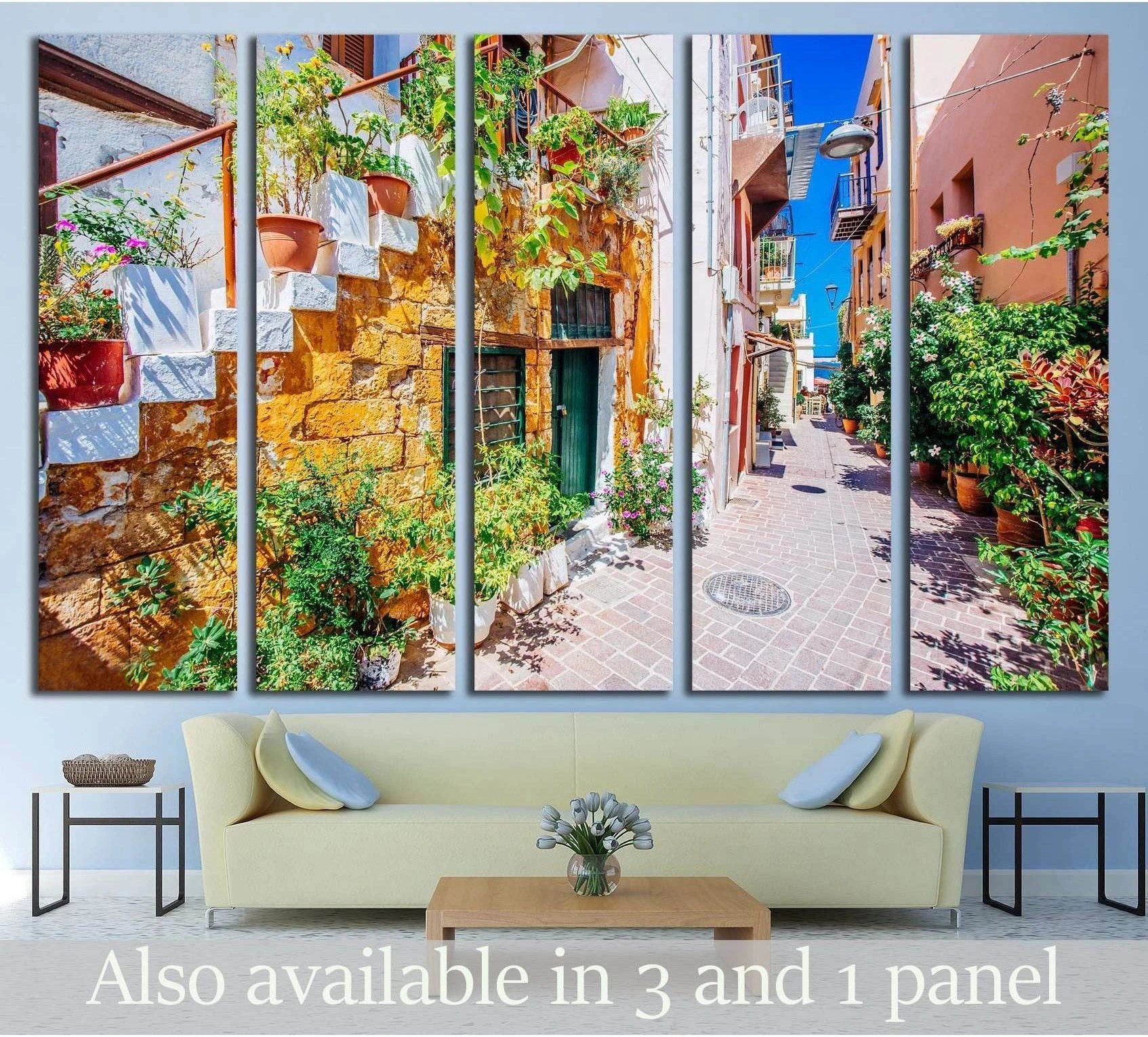 Chania street canvas print with stone steps, flower pots, and greenery above a sofa in a modern living room