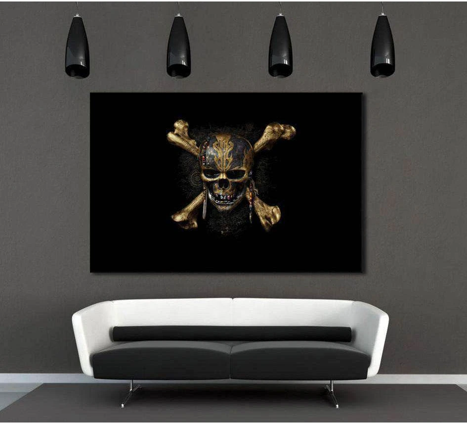 Gold pirate skull and crossbones canvas print on black, displayed above a sofa in a dark modern living room