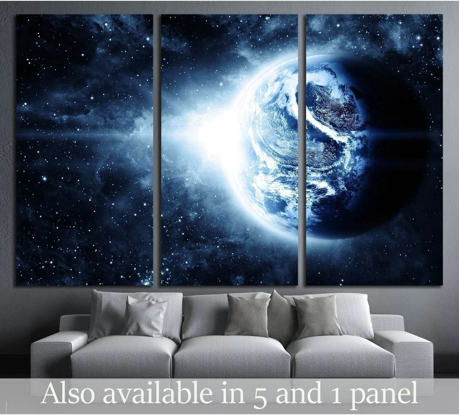 Blue Earth space canvas print in a triptych layout above a sofa in a modern living room