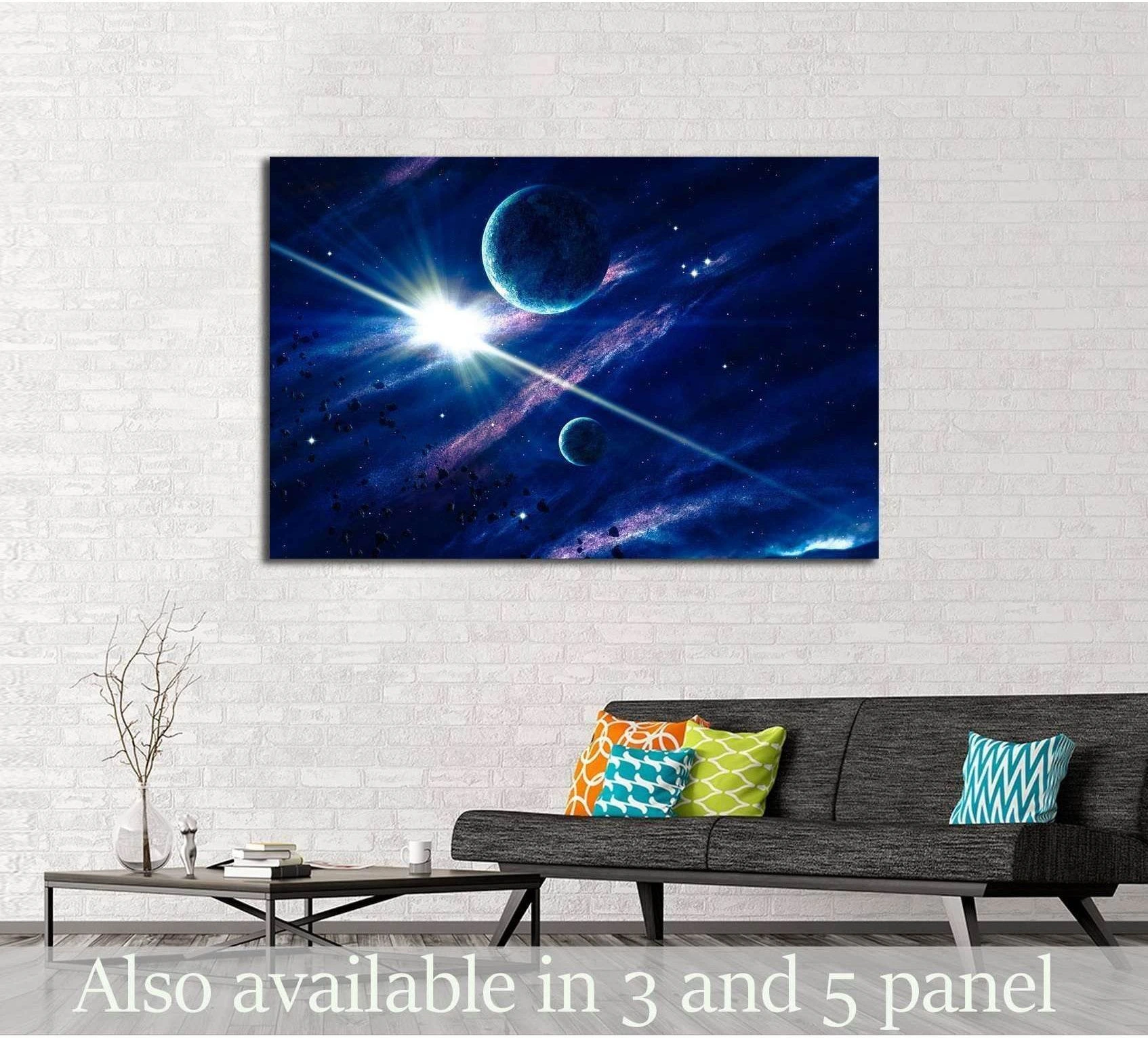 Blue space canvas print with glowing starburst and planets above a sofa in a modern living room
