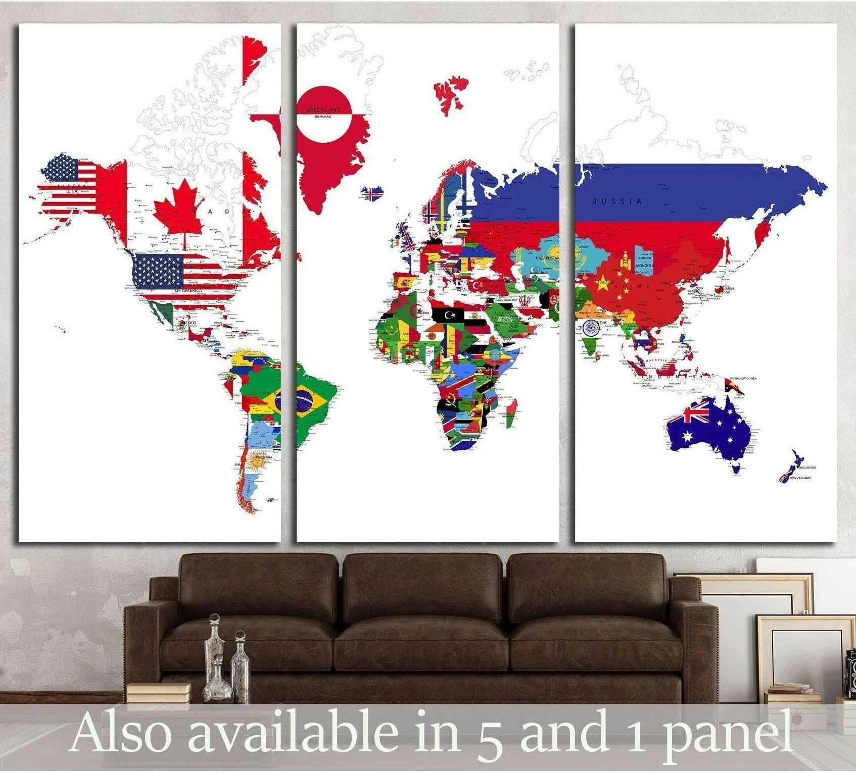 Political world map canvas print with country flags in a triptych layout above a brown sofa