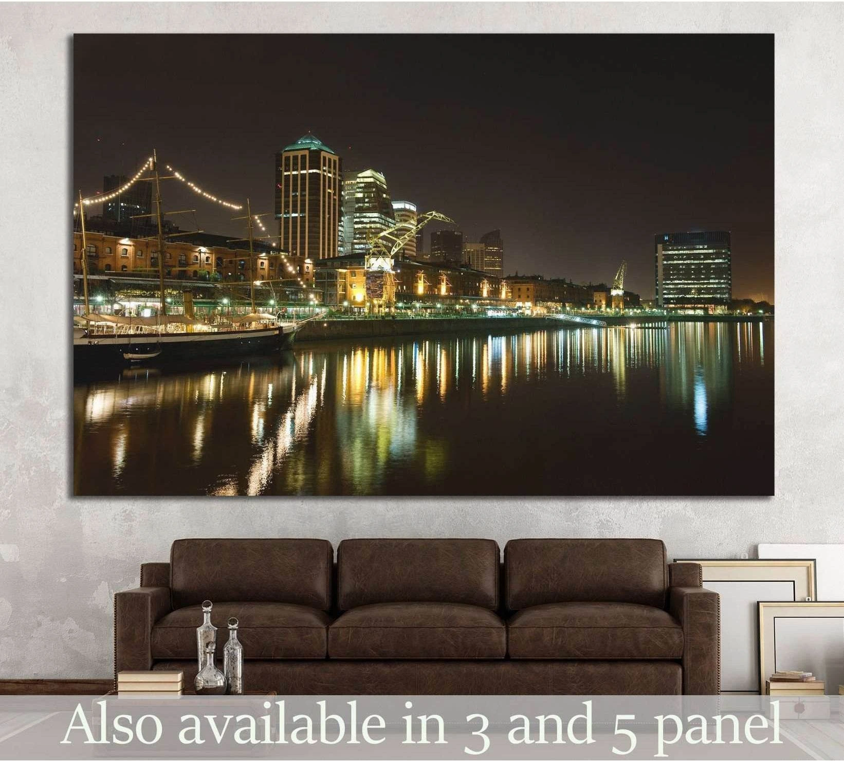 Puerto Madero Buenos Aires night skyline canvas print hung above a brown sofa with waterfront reflections