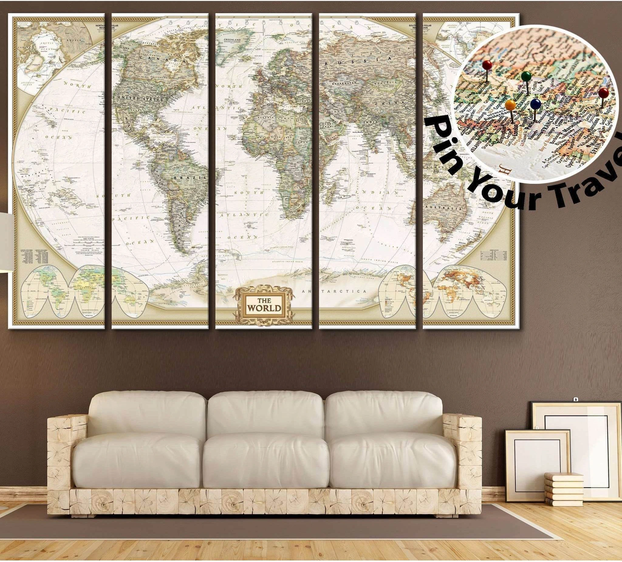 Push pin world map canvas print in antique sepia tones above a sofa in a warm neutral living room
