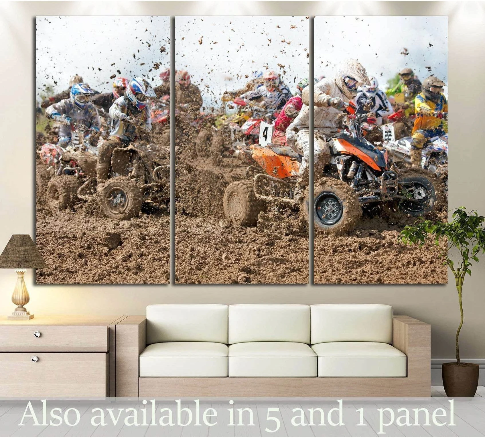 ATV mud race triptych canvas print with quad bikers splashing through mud, displayed above a sofa in a modern living room