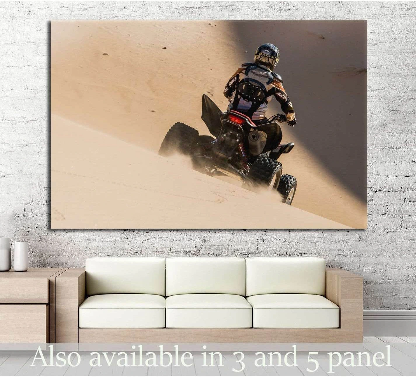 ATV rider carving down a sand dune canvas print displayed above sofa in modern living room
