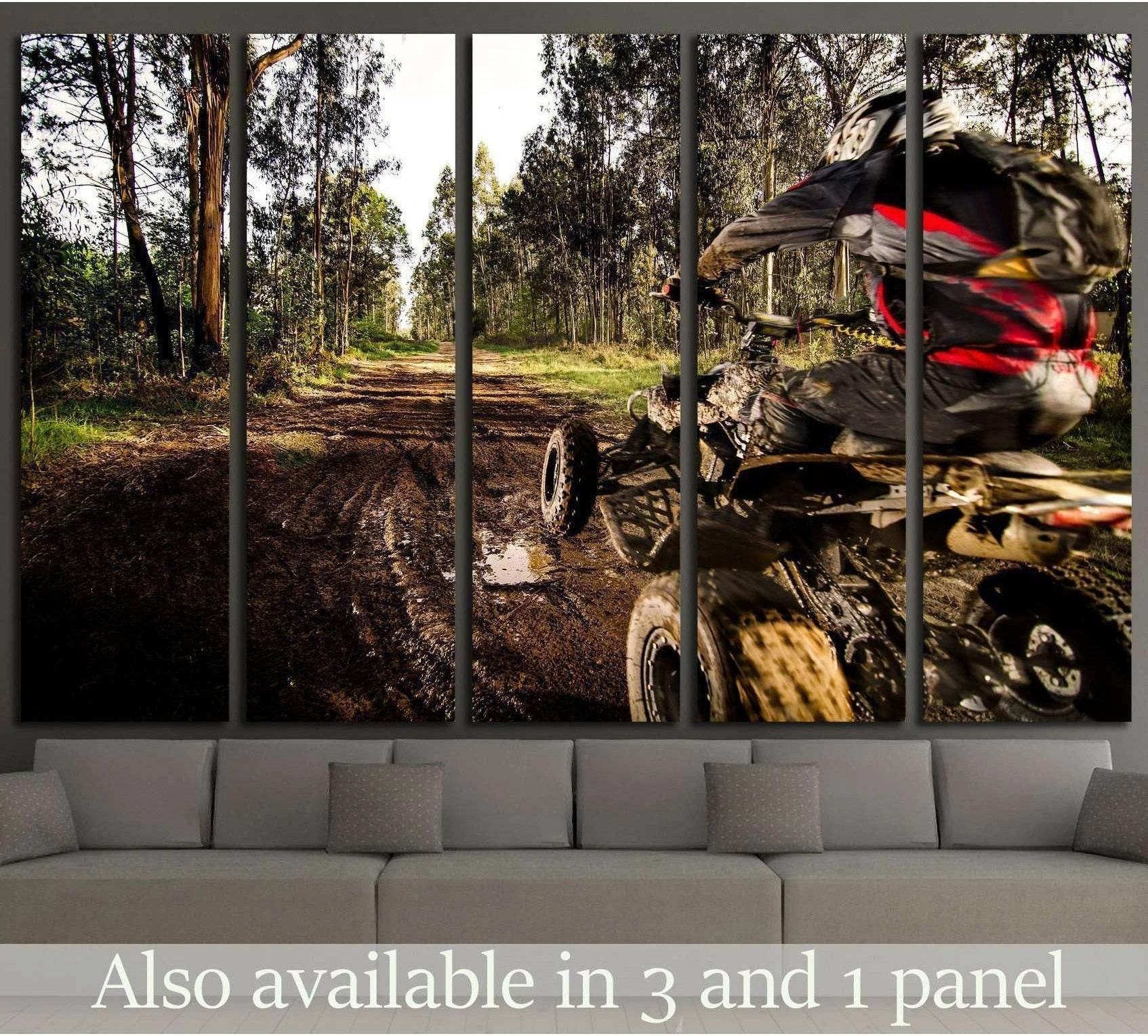 ATV rider canvas print with quad bike on a muddy forest trail, displayed above a sofa