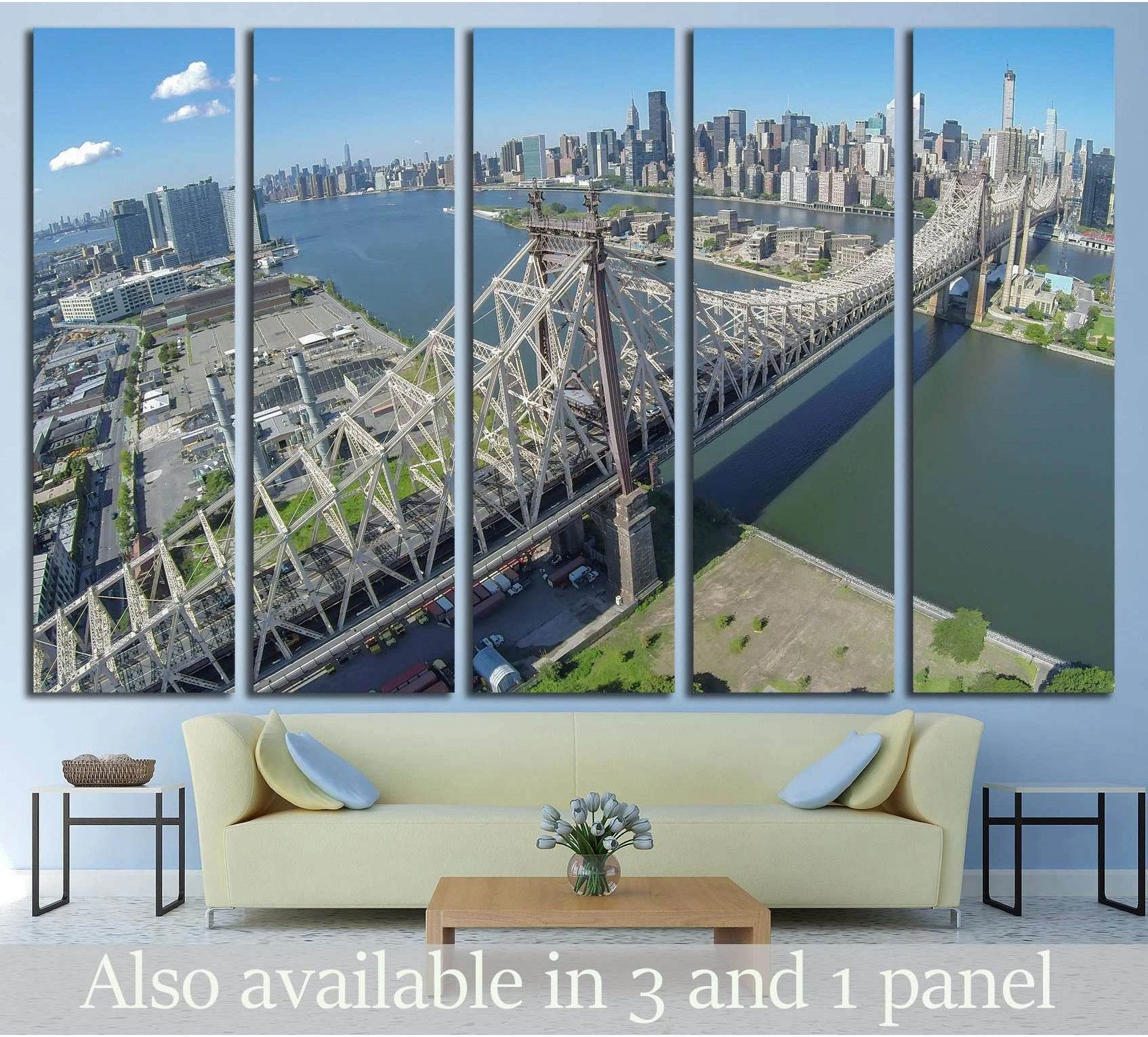 Queensboro Bridge canvas print with aerial NYC skyline view above sofa in modern living room