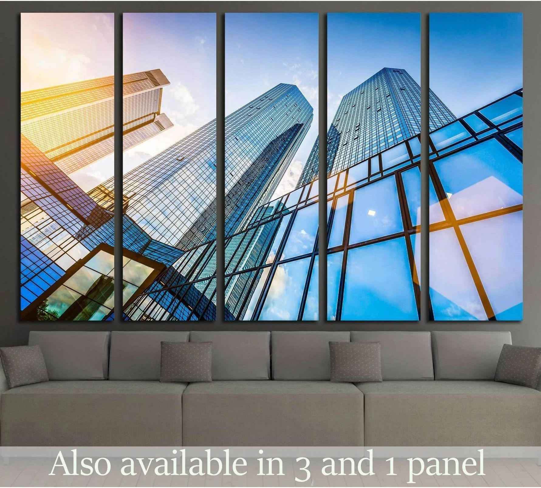 Modern skyscraper canvas print with blue glass towers and golden light, displayed above a sofa
