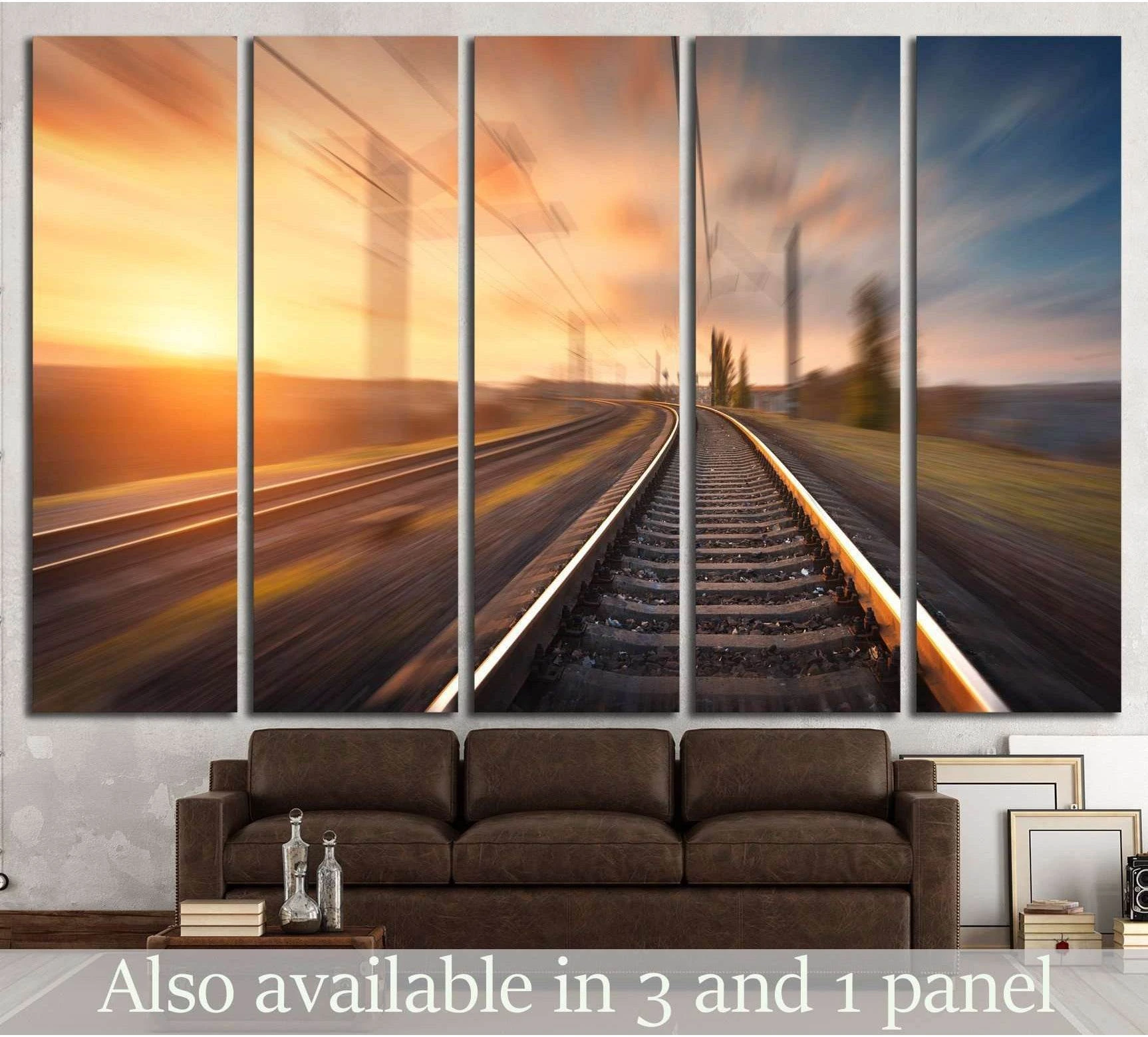 Sunset train tracks canvas print with motion blur, curved railway line, and power poles above a sofa