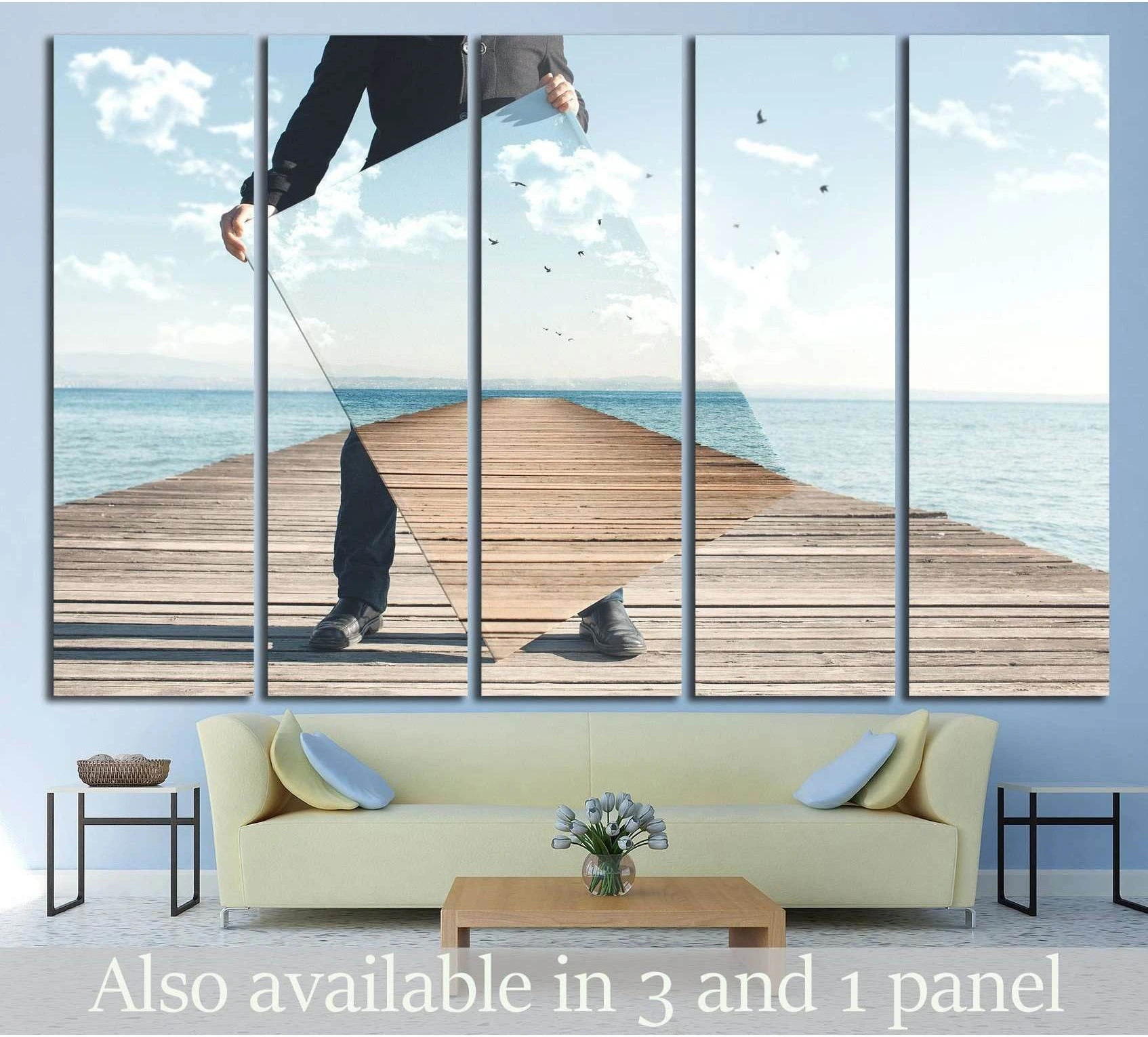 Surreal pier canvas print with mirrored coastal boardwalk scene, hung above a sofa in a modern living room