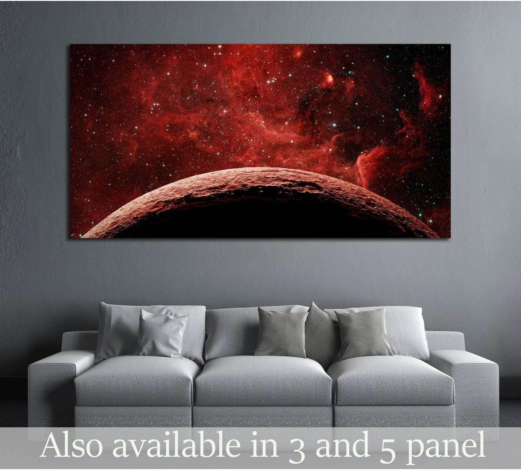 Red planet canvas print with crimson nebula and stars displayed above a gray sofa