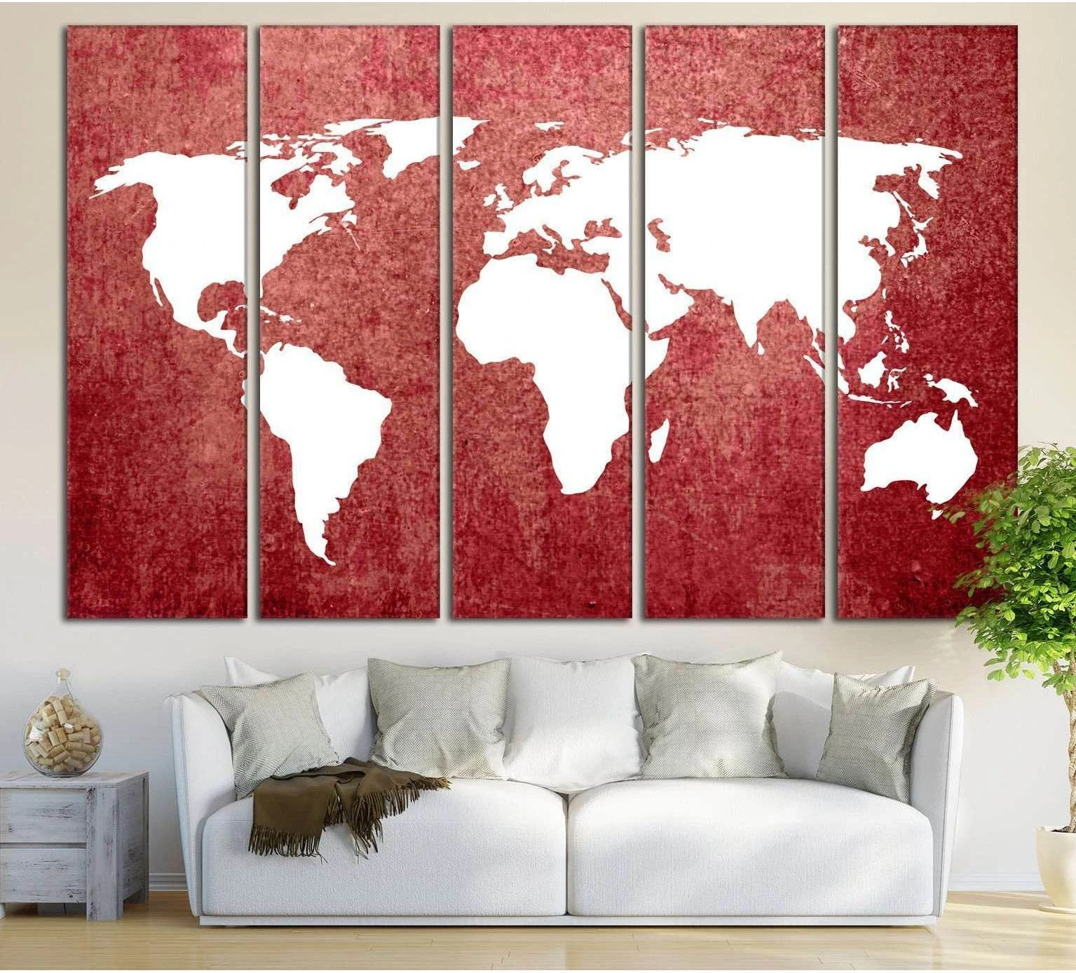 Five-panel red world map canvas print above a white sofa in a modern living room