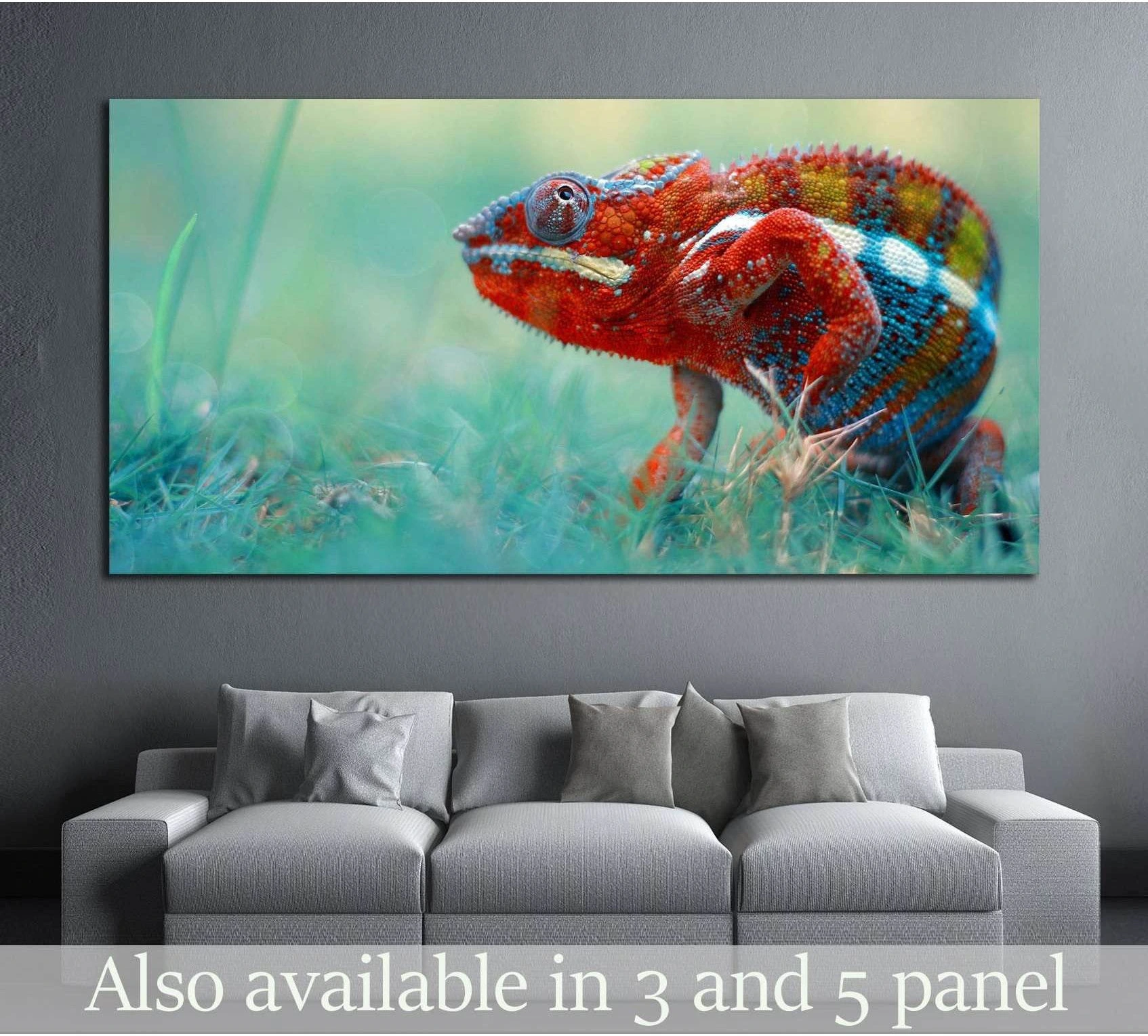 Colorful chameleon canvas print with red and turquoise scales displayed above a gray sofa