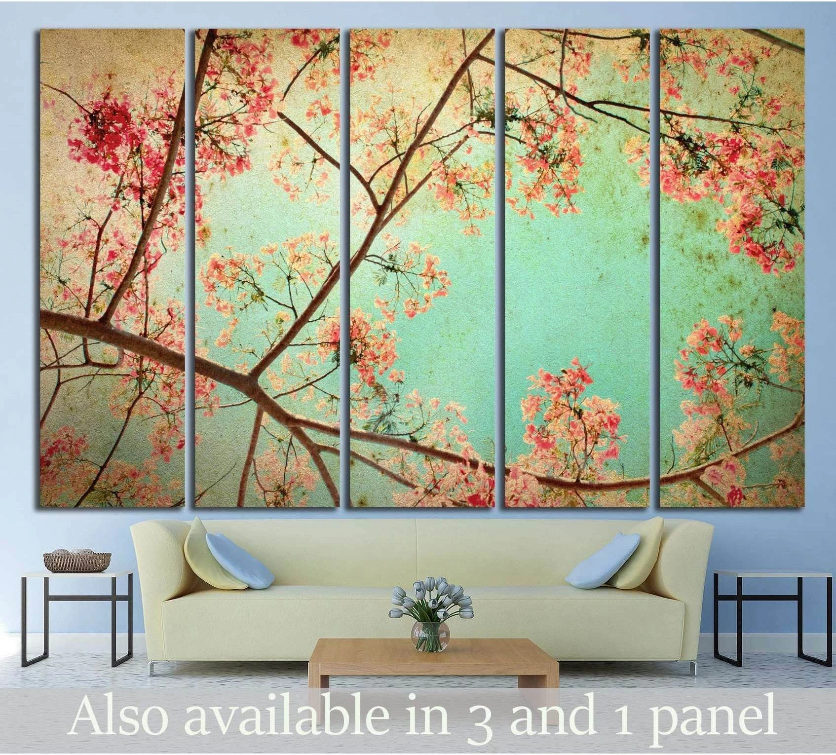 Cherry blossom canvas print with pink branches on a vintage aqua background above a sofa
