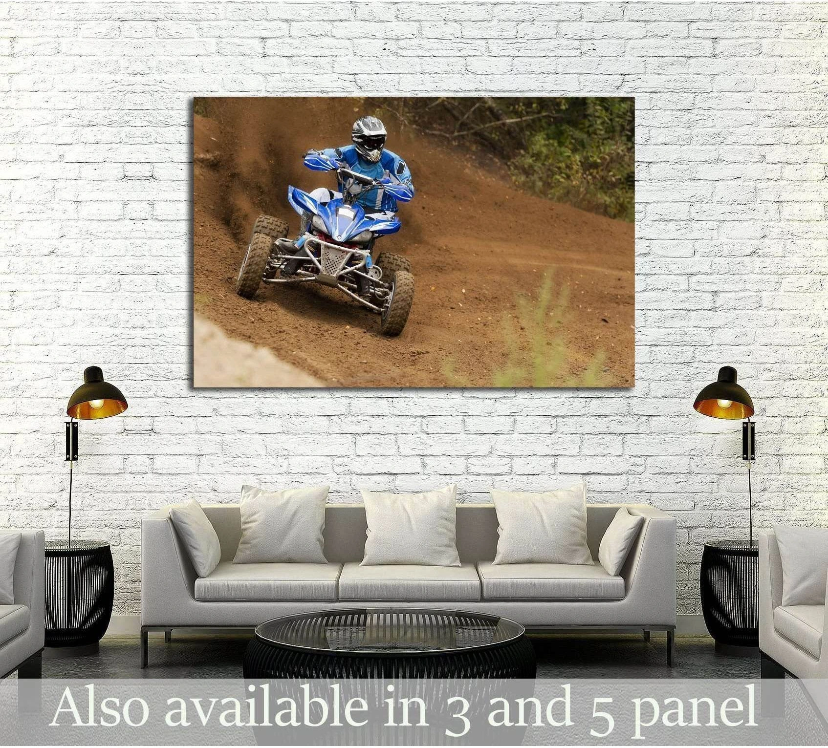 Blue ATV rider racing canvas print hung above a sofa in a modern living room mockup